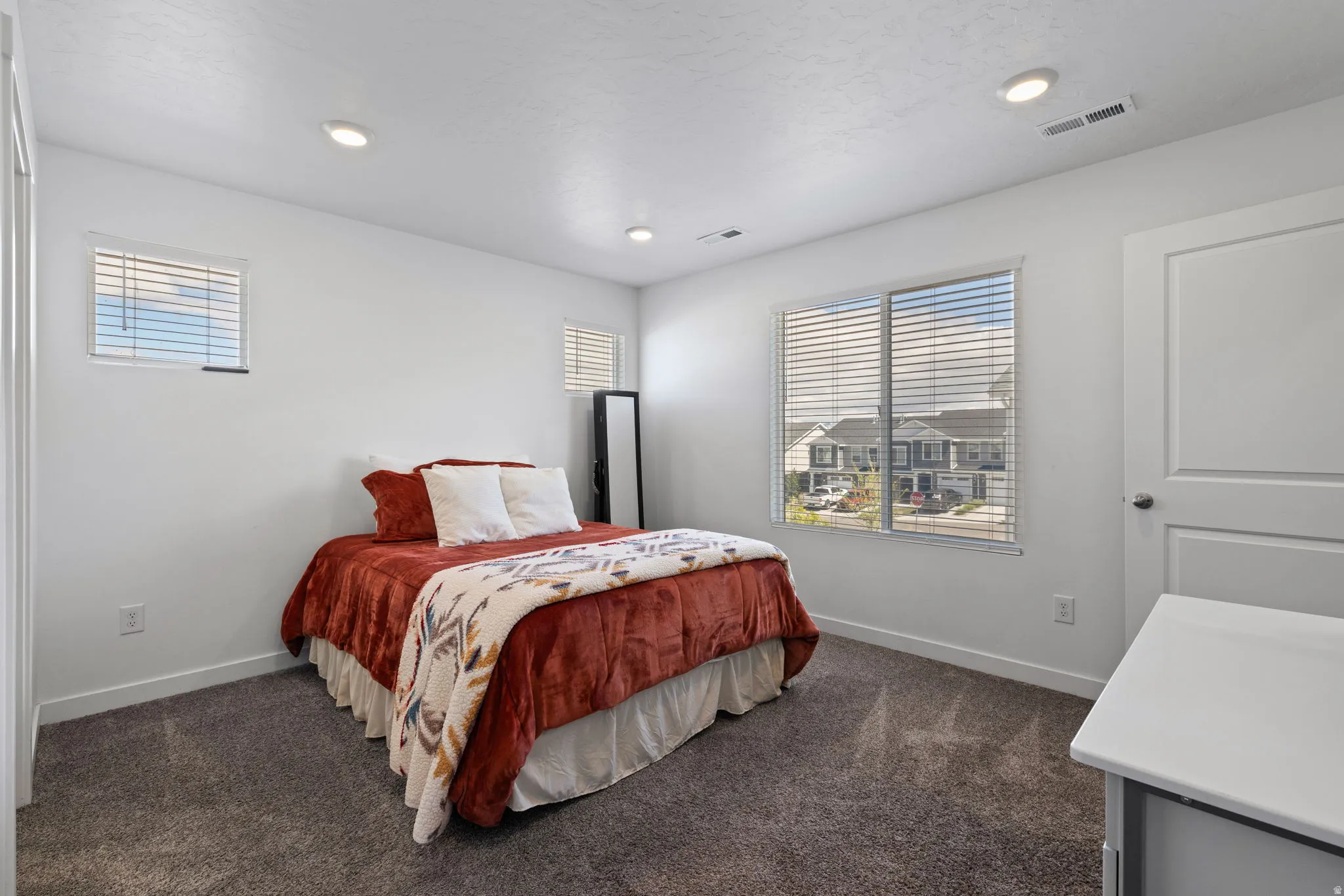Bedroom featuring dark colored carpet and recessed lighting