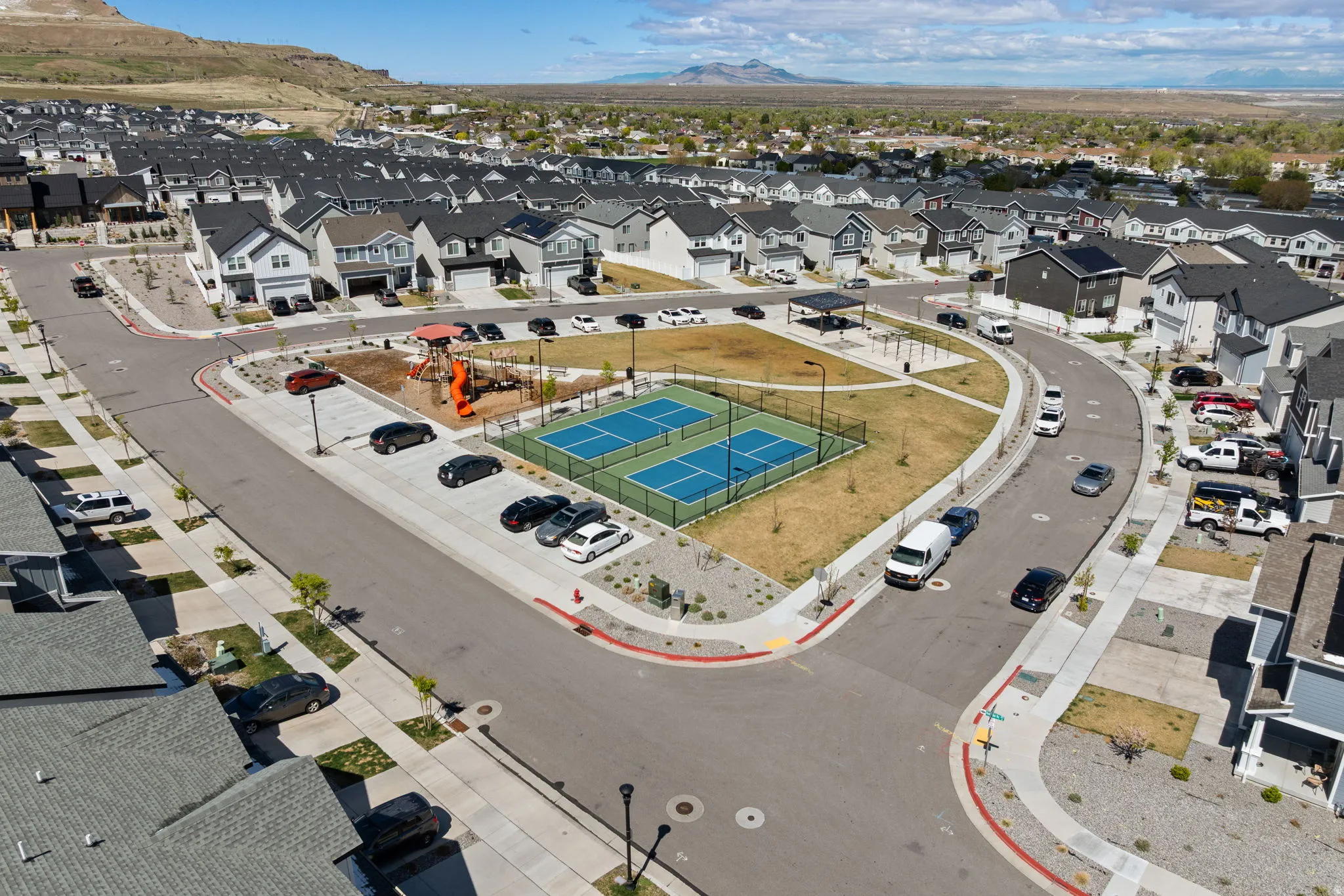 Aerial perspective of suburban area with a mountainous background