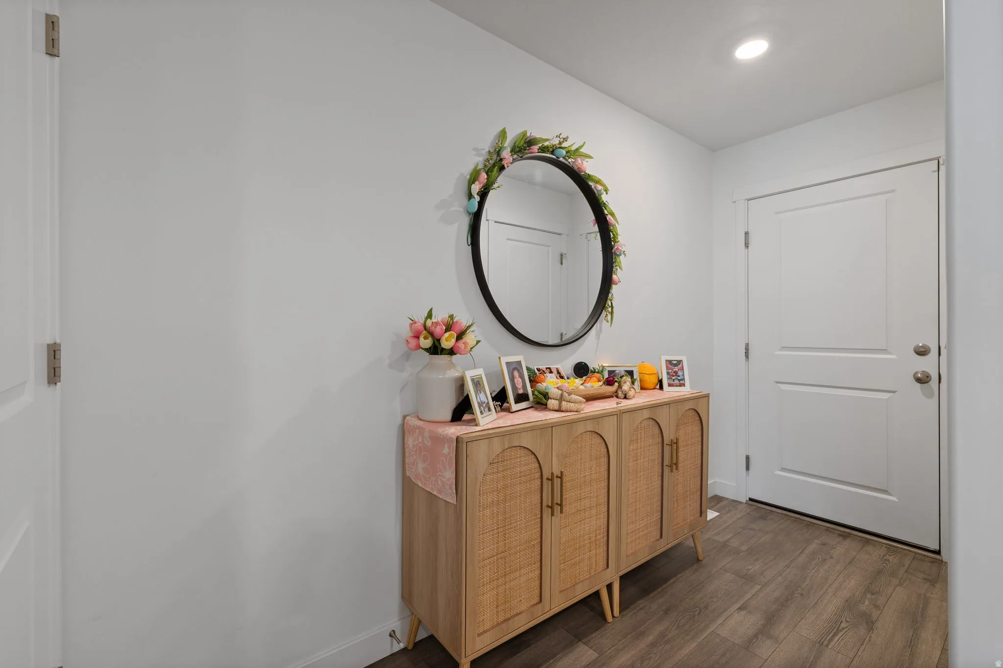 Hall with dark wood-type flooring and baseboards