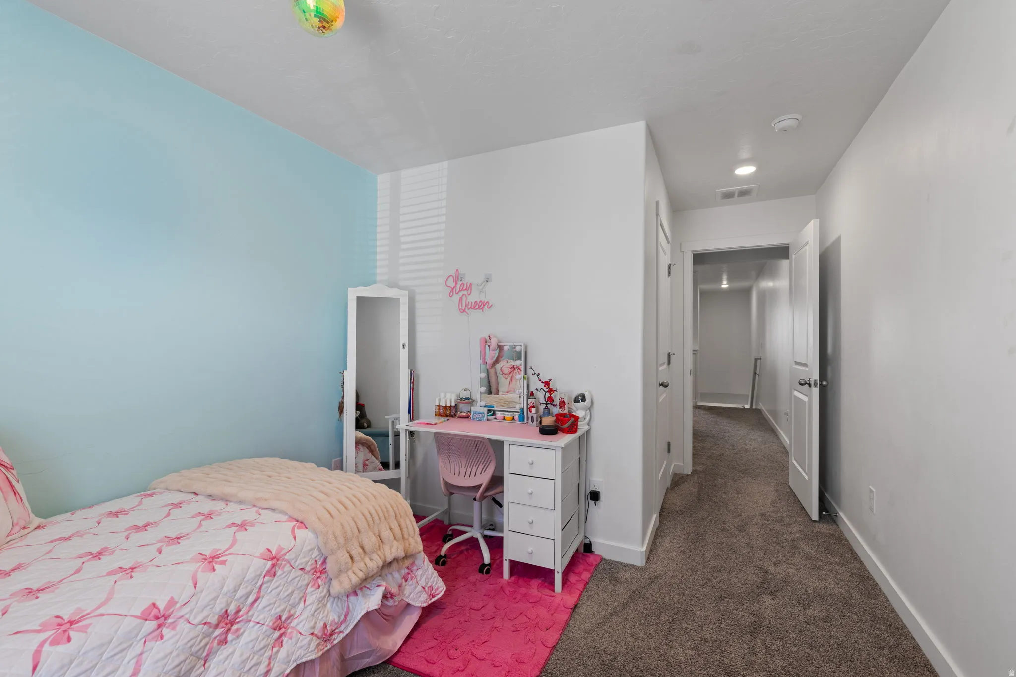 Bedroom with carpet and an office area