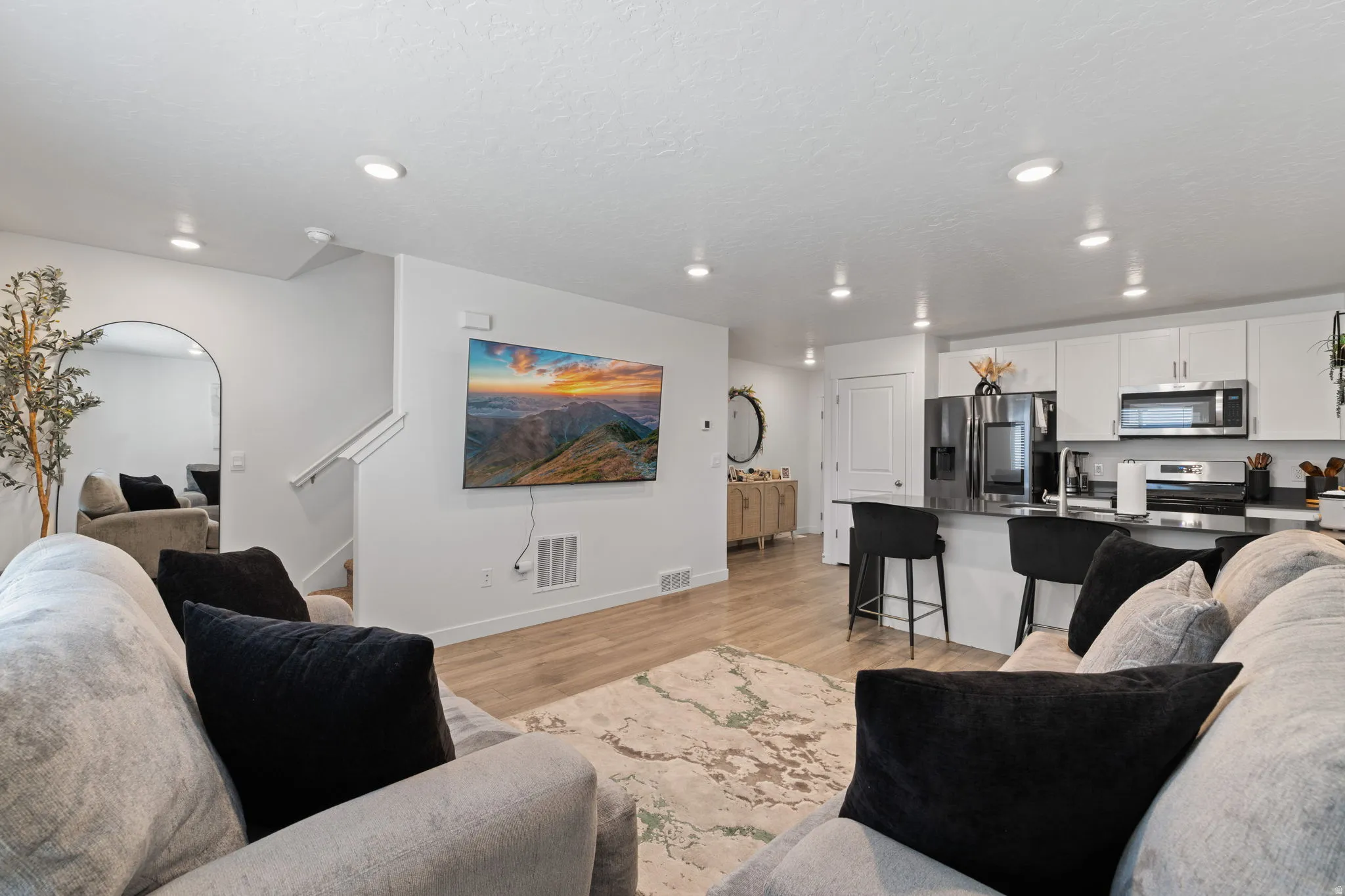 Living room featuring light wood-type flooring and recessed lighting