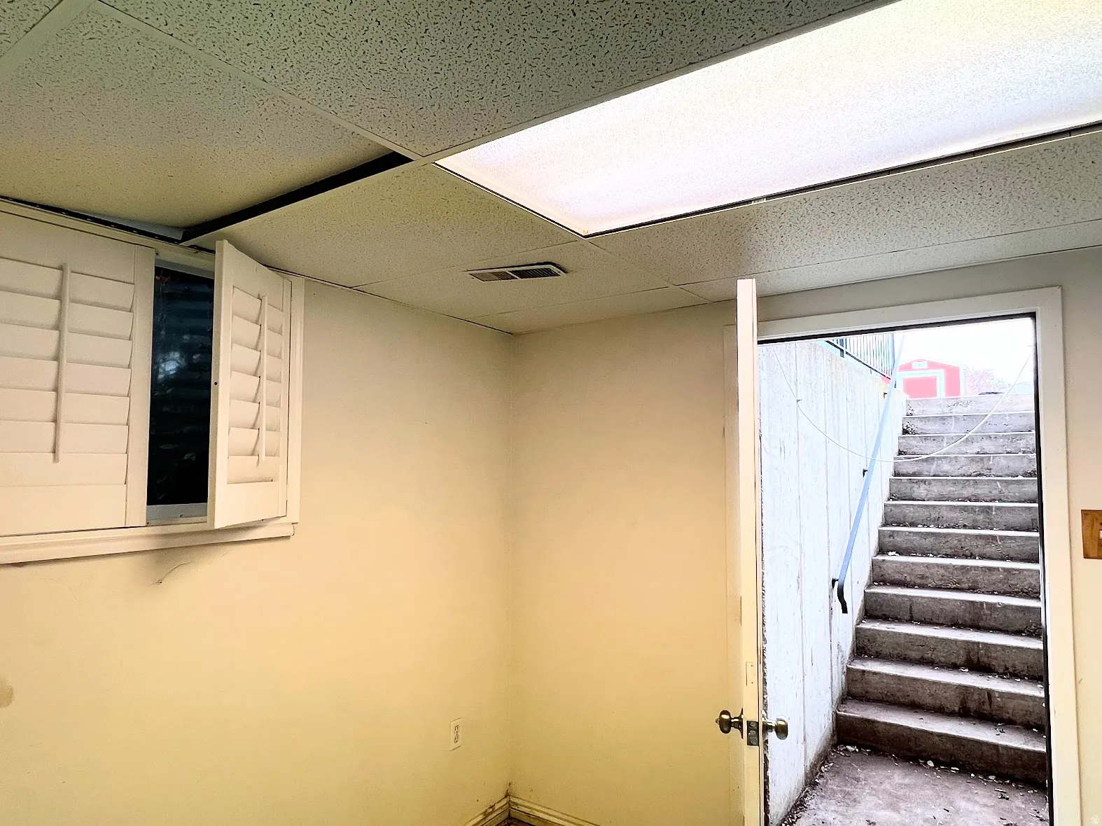 Below grade area with stairs and a paneled ceiling