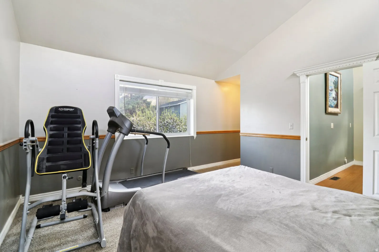 Bedroom with vaulted ceiling and baseboards