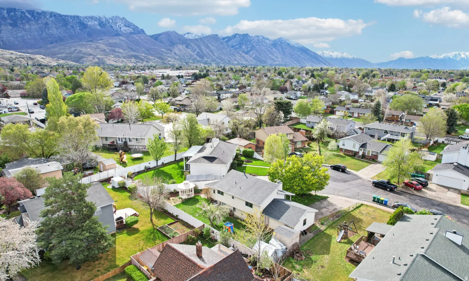 Aerial perspective of suburban area featuring a mountain backdrop