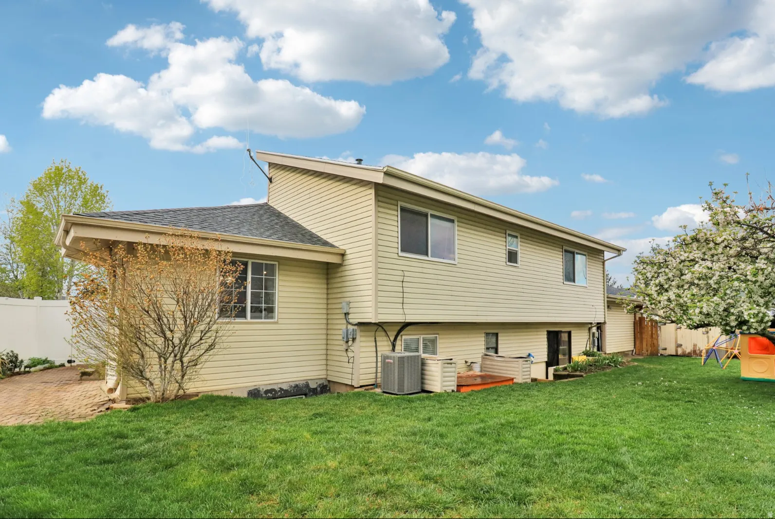 Back of property with a shingled roof