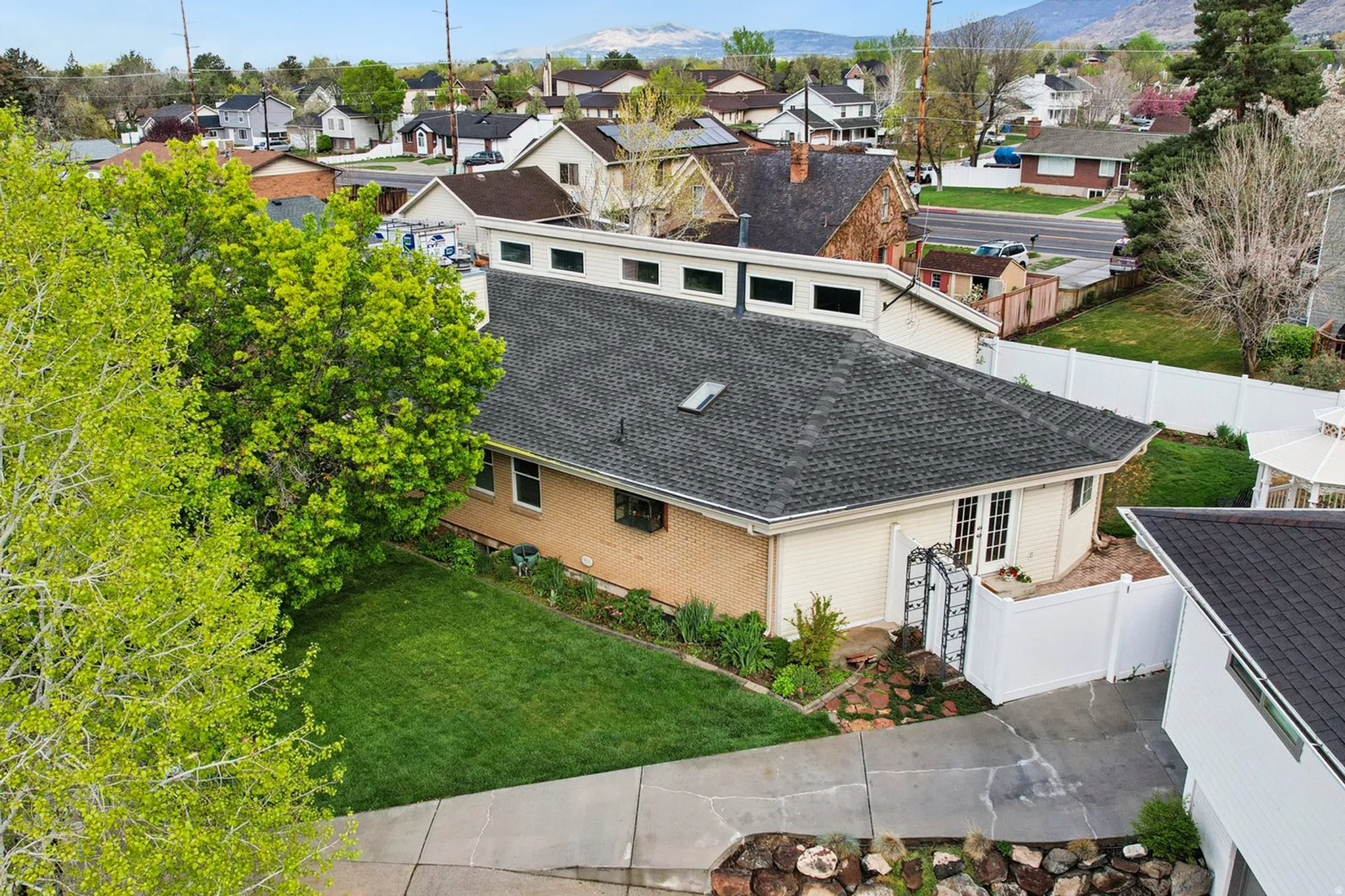 Aerial perspective of suburban area featuring a mountain backdrop