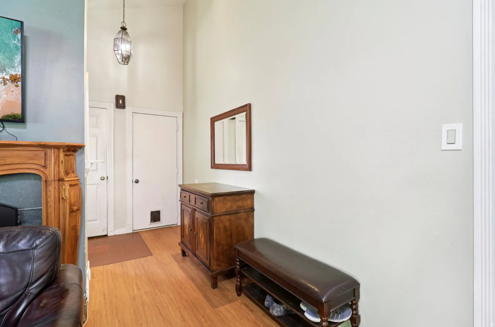 Living area featuring light wood finished floors and a high ceiling
