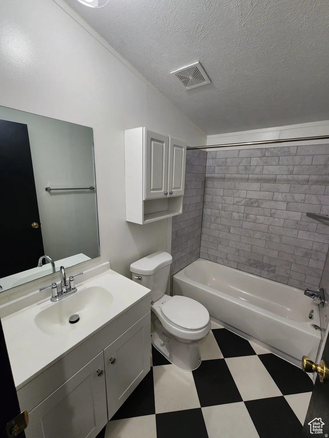 Full bathroom with light floors, vanity, and tub / shower combination