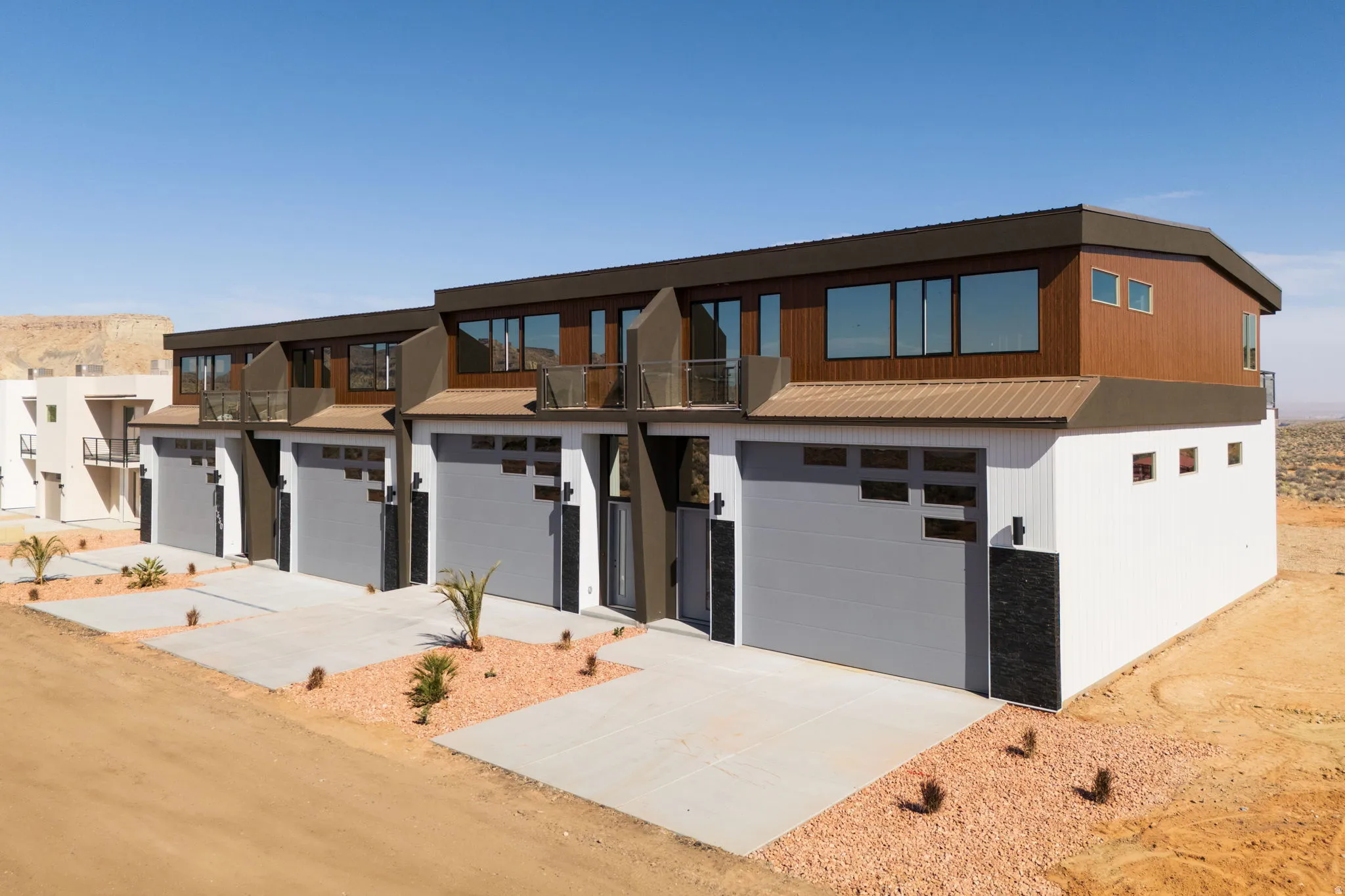 Contemporary house with concrete driveway and an attached garage