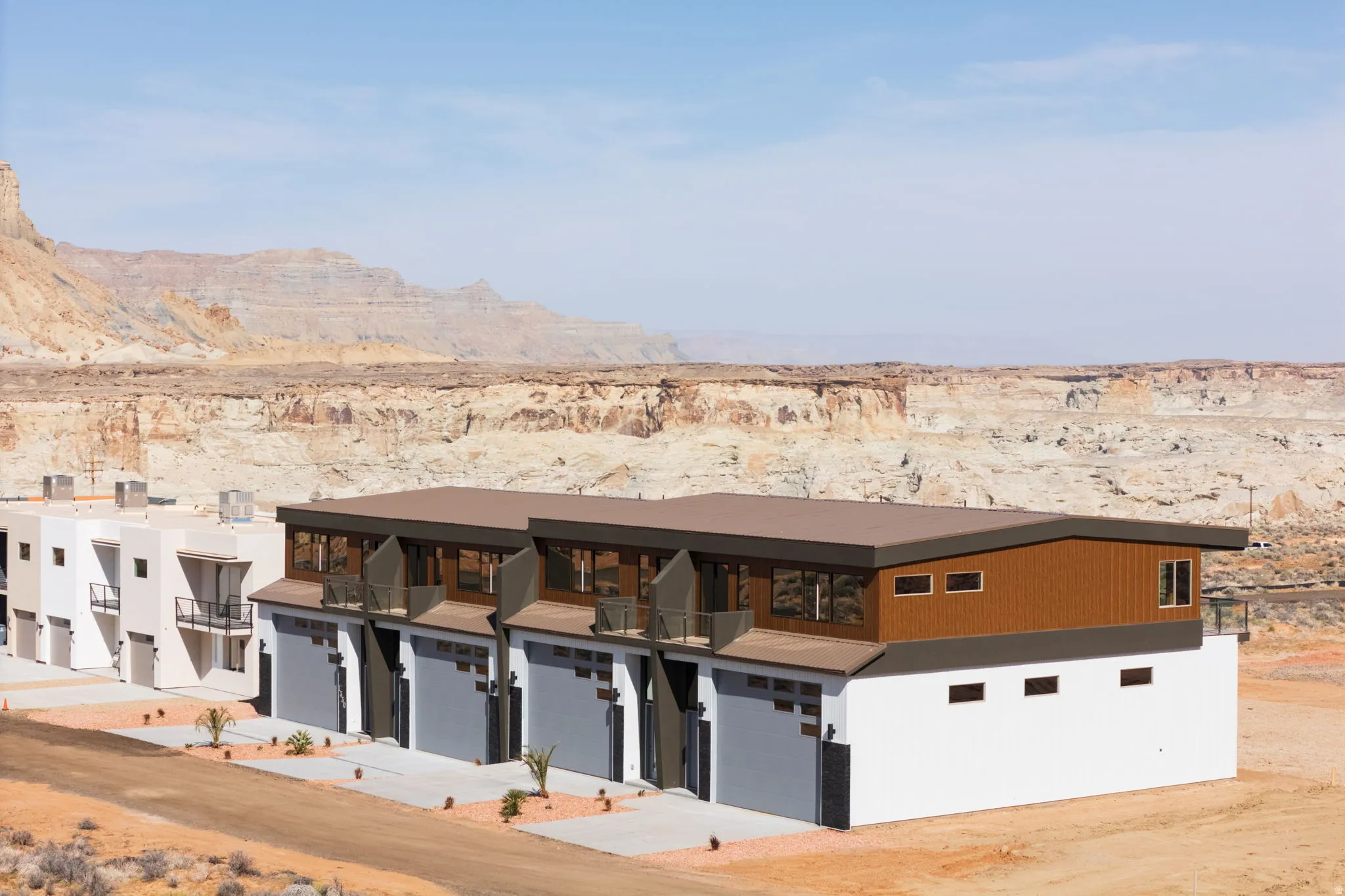 View of front of house with a mountain view, view of desert, and driveway