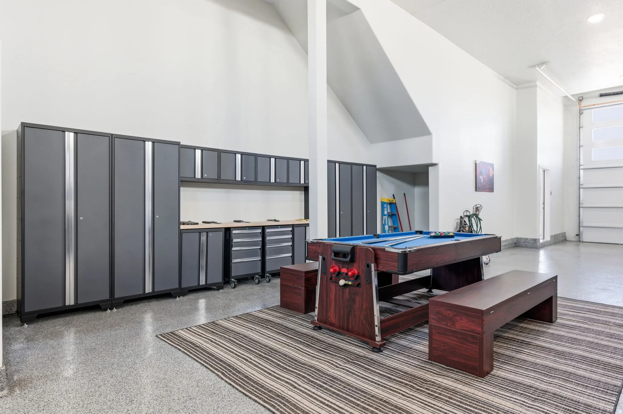 Recreation room with a high ceiling, billiards table, and speckled floor