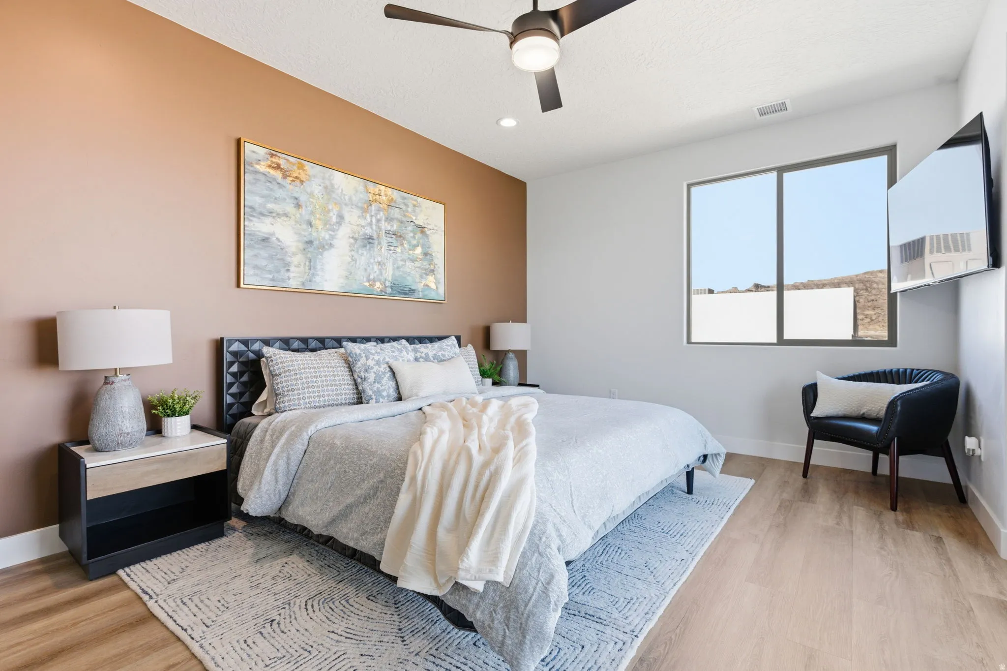 Bedroom with light wood-style flooring, ceiling fan, and recessed lighting