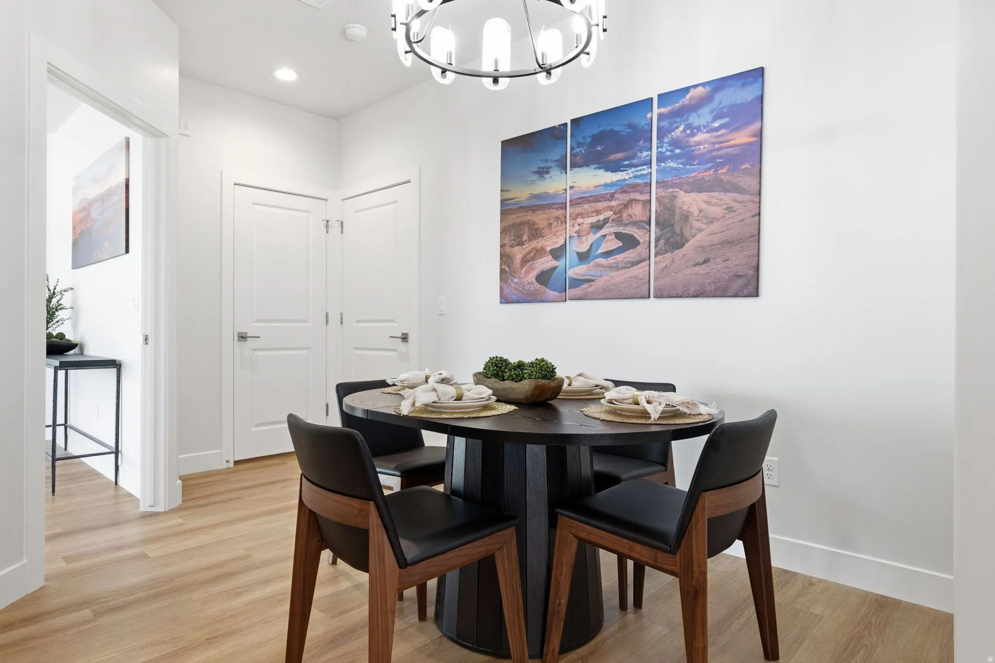 Dining area featuring light wood-style flooring and suspended lighting