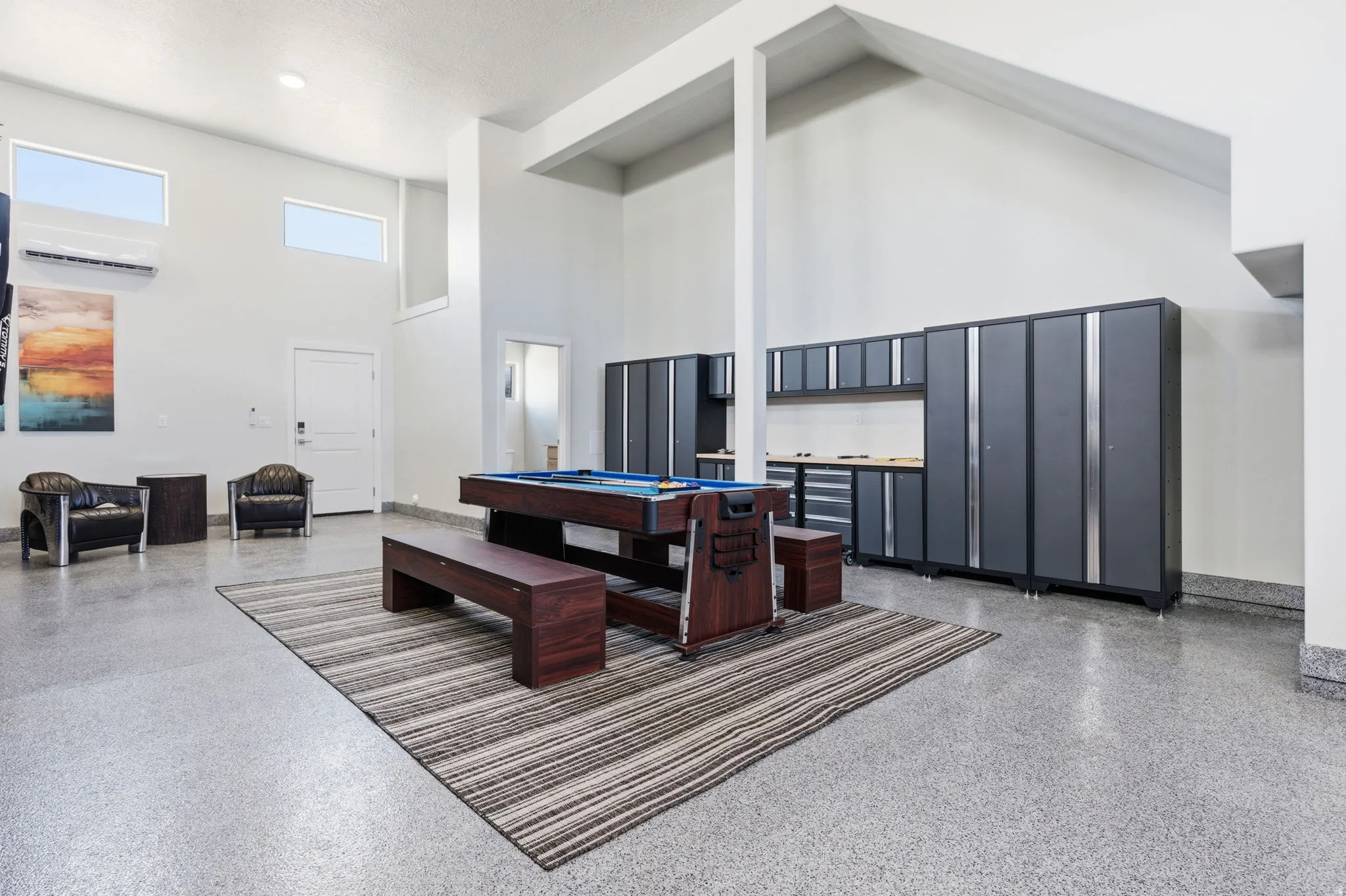 Game room featuring a high ceiling, pool table, and speckled floor