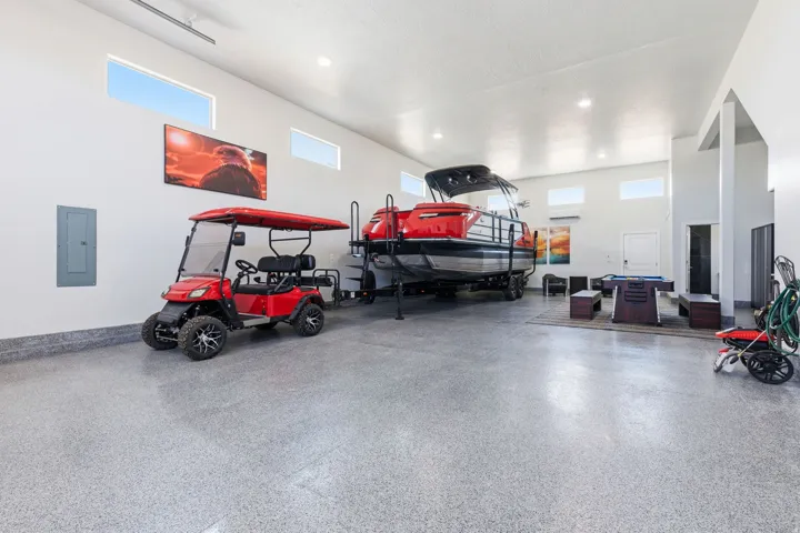 Garage with electric panel and recessed lighting