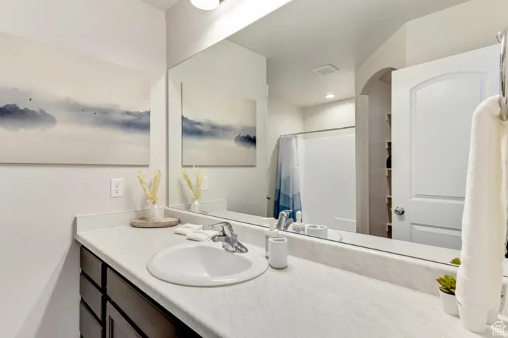 Full bathroom featuring vanity, a shower with shower curtain, and recessed lighting