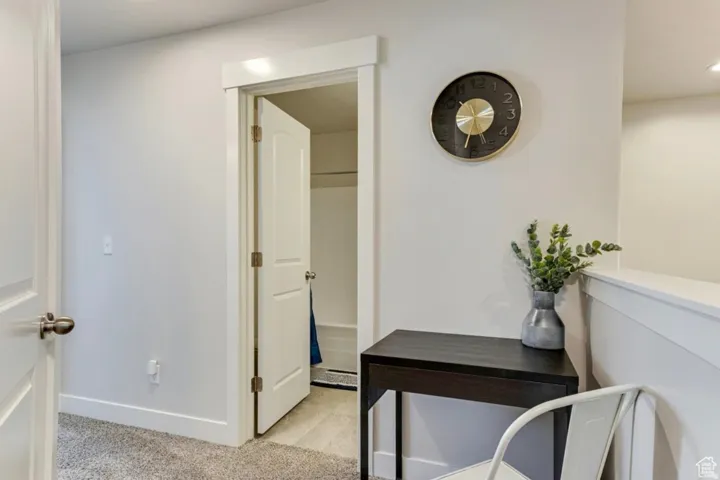 Office with light carpet and recessed lighting