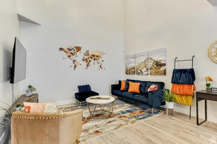 Living area with wood finished floors and a high ceiling