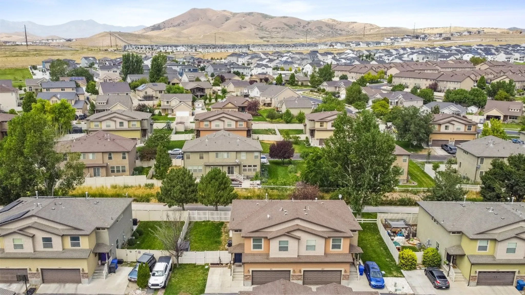 Aerial view of residential area featuring a mountainous background