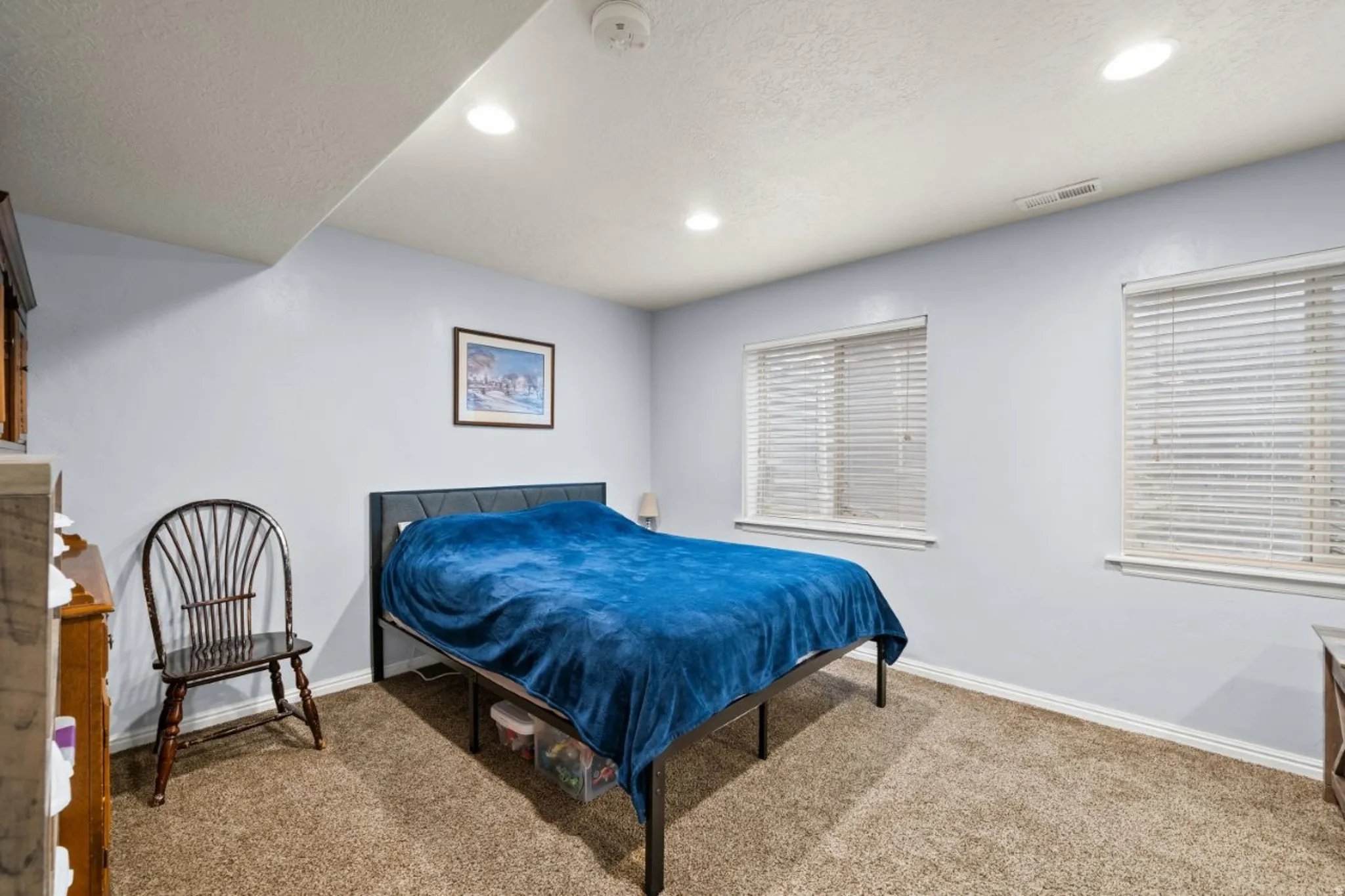 Bedroom with carpet, a textured ceiling, and recessed lighting