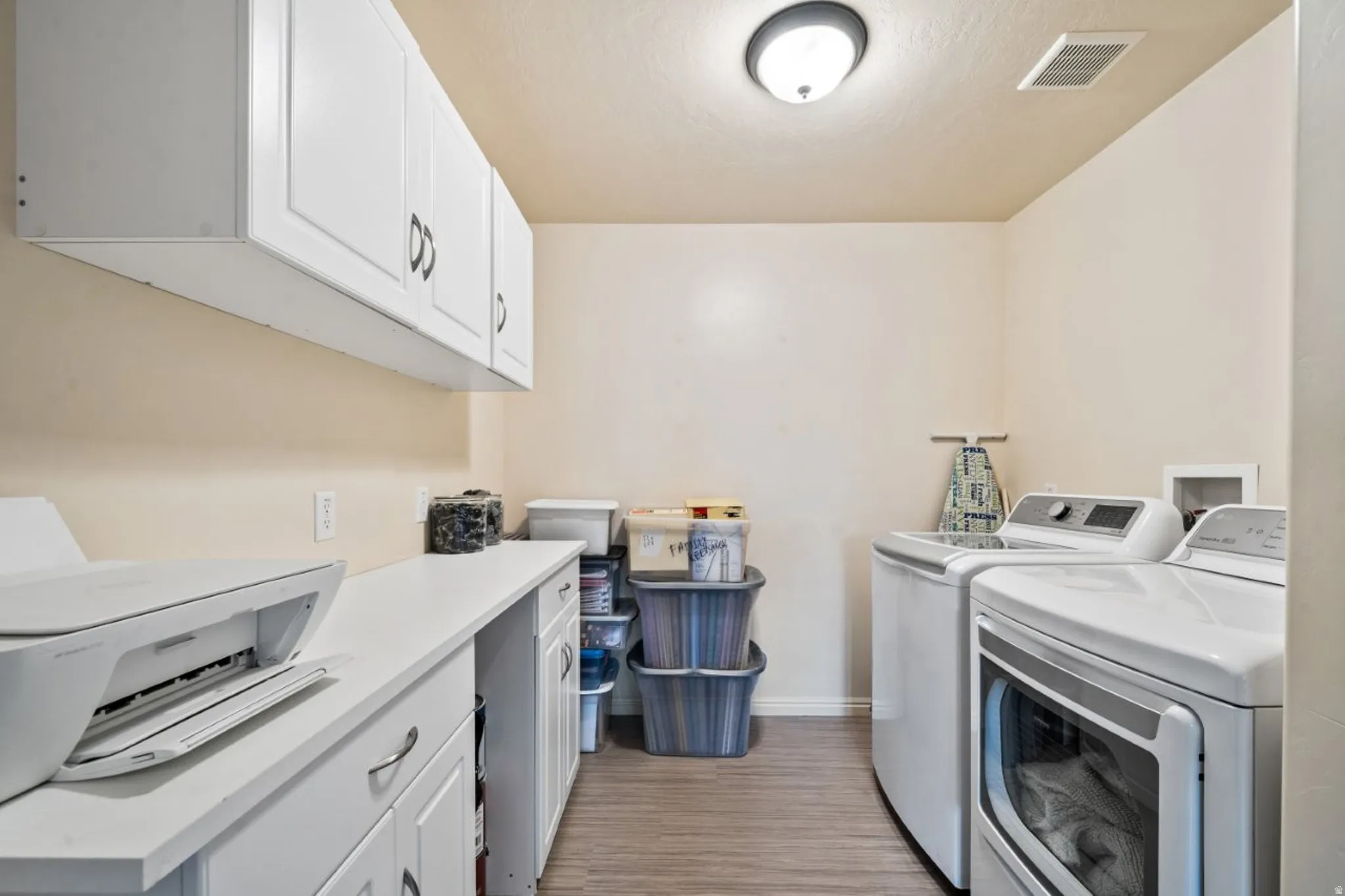 Laundry area featuring cabinet space and washing machine and dryer