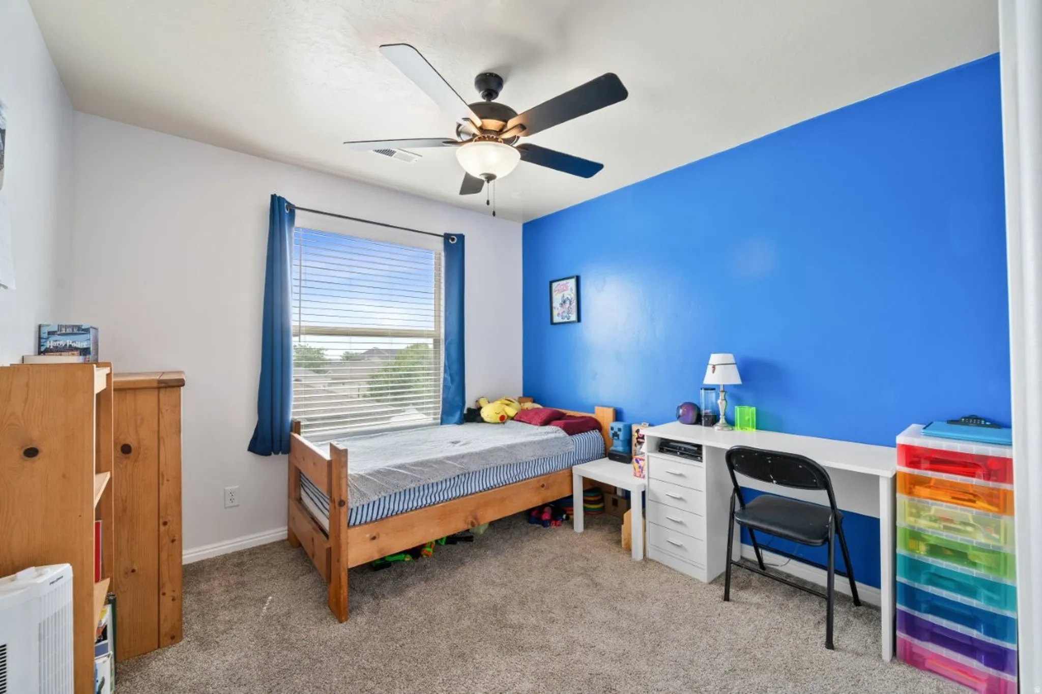 Bedroom with light colored carpet and ceiling fan