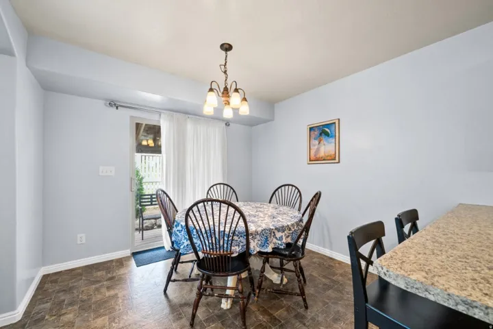 Dining room featuring stone finish floors and suspended lighting