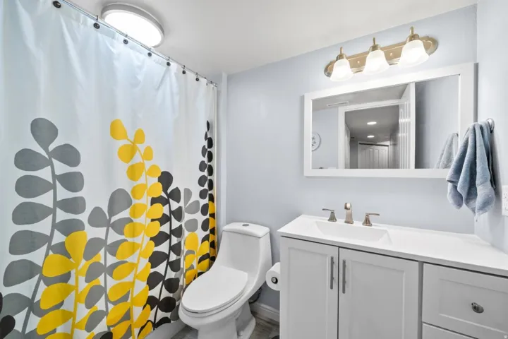 Full bath with vanity and curtained shower