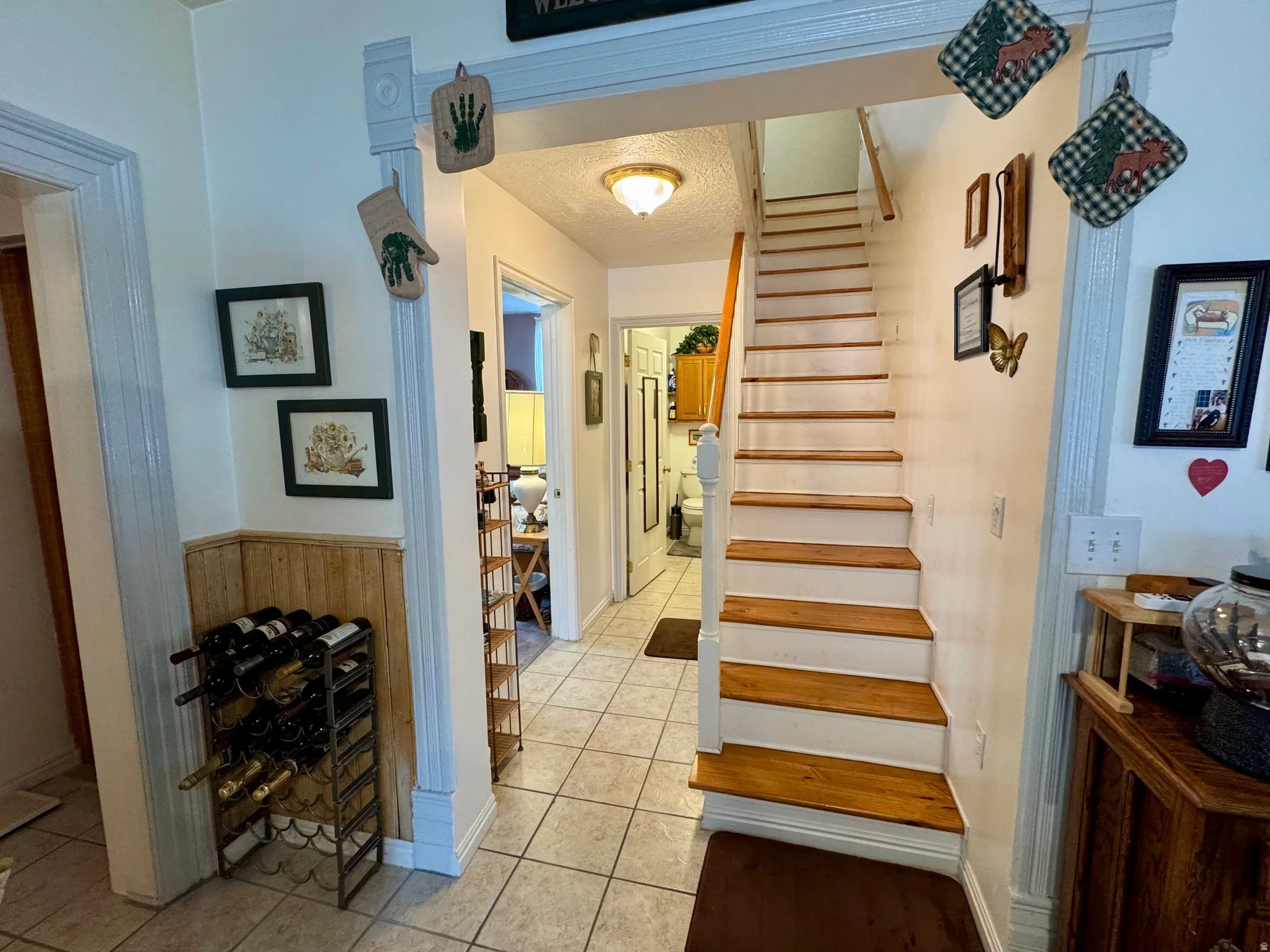 Staircase featuring tile patterned floors and a textured ceiling