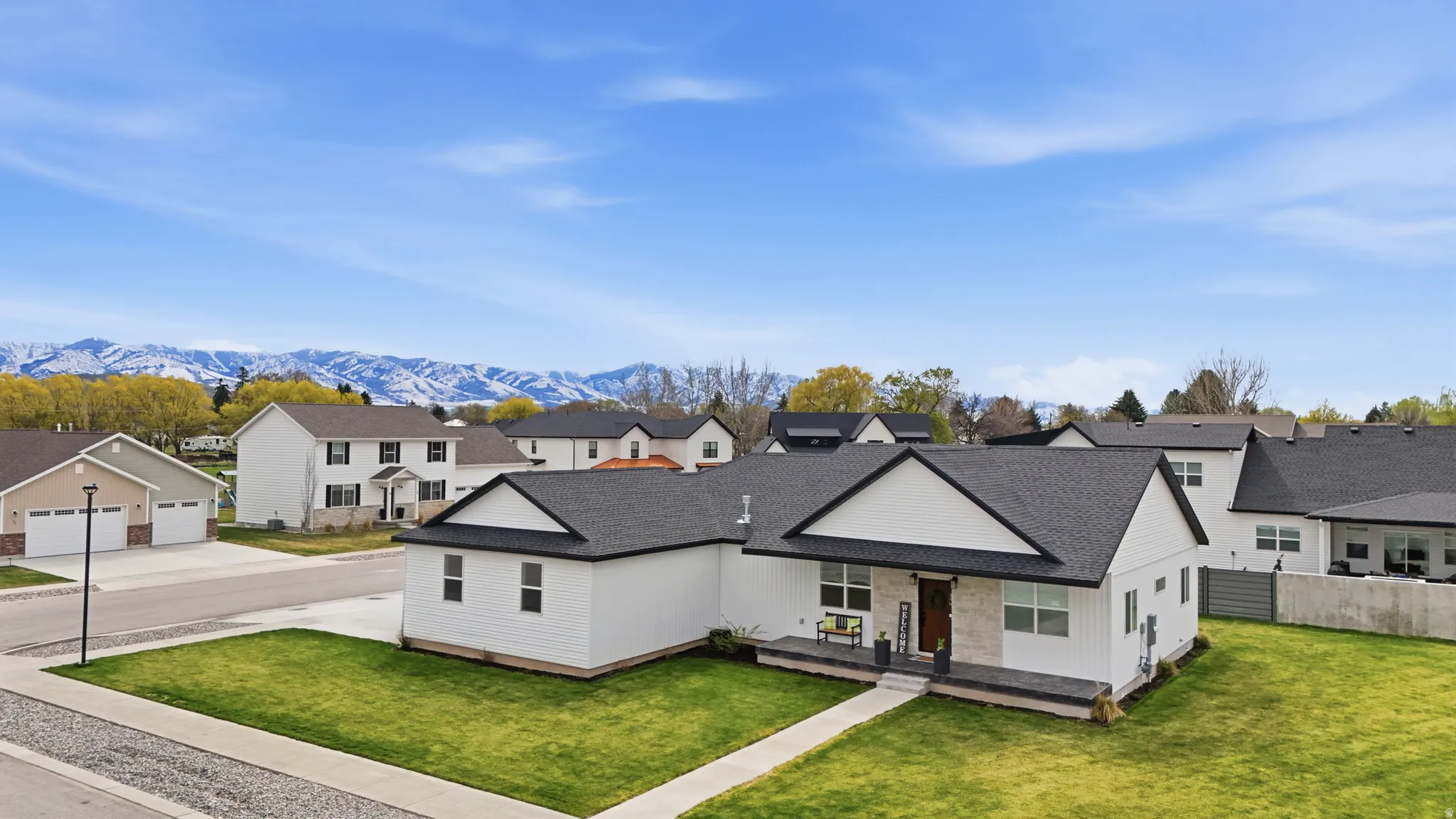 Modern farmhouse featuring a residential view, a porch, a shingled roof, and a front yard