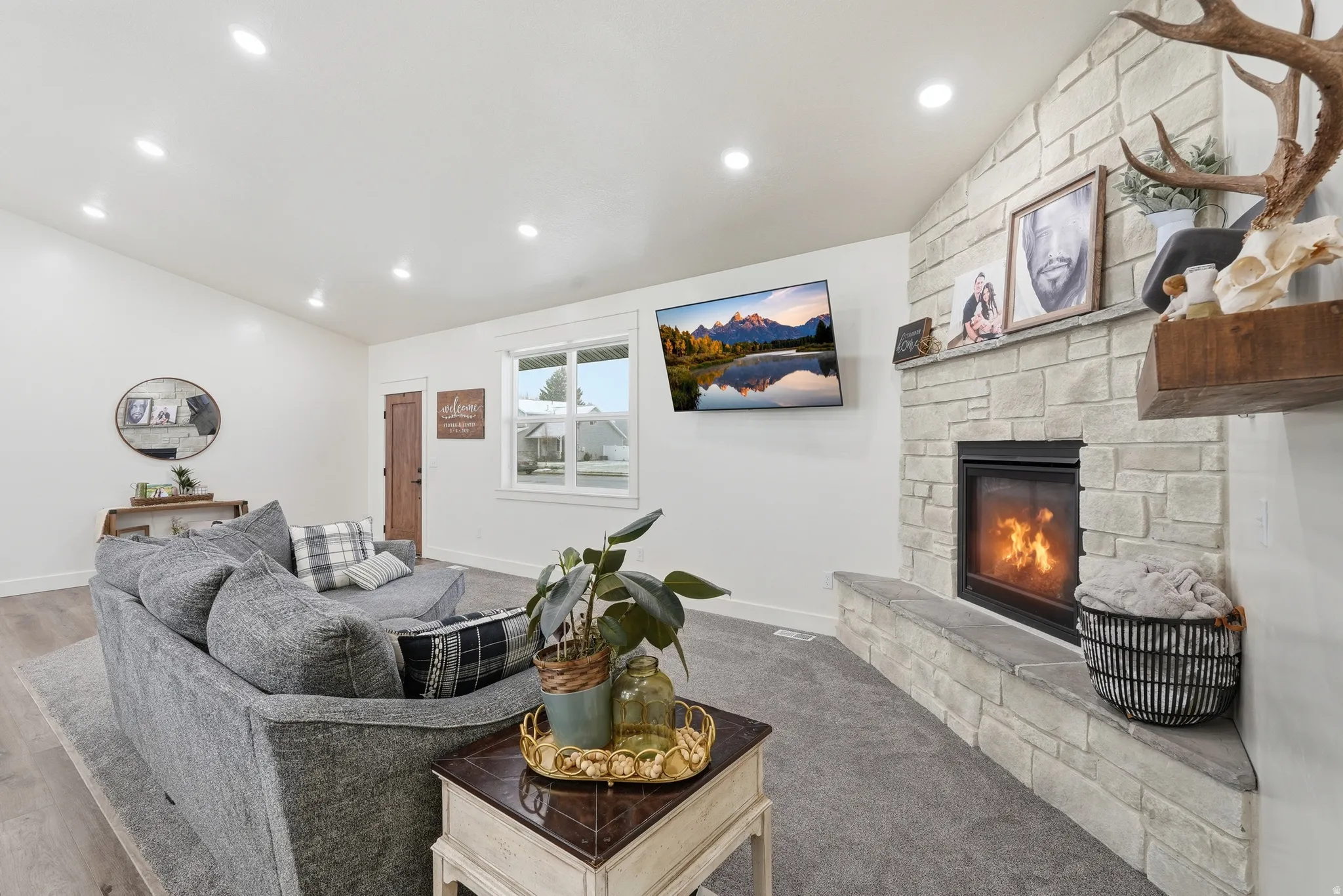 Living area with lofted ceiling, a fireplace, and recessed lighting