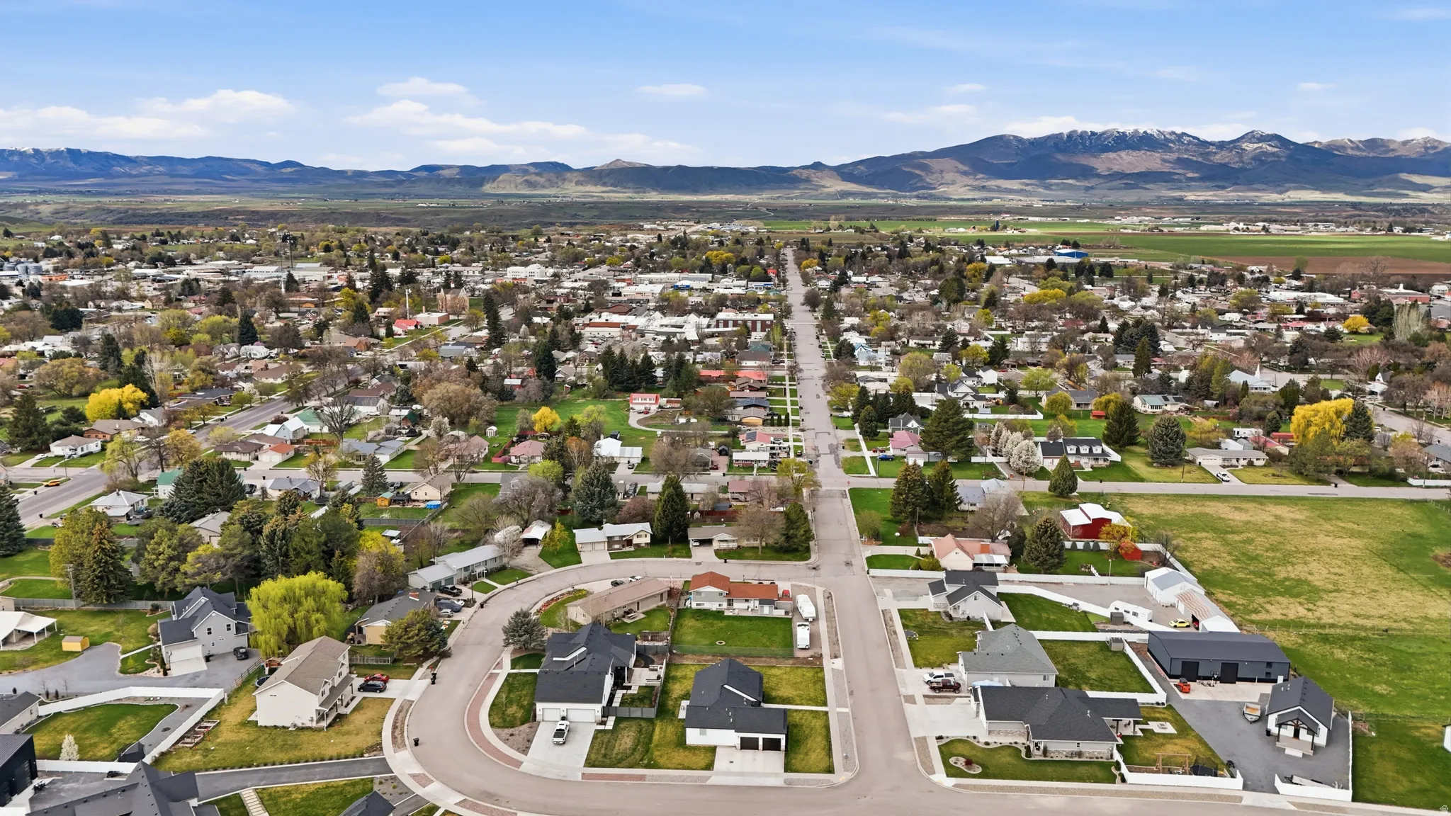 Aerial perspective of suburban area featuring a mountain backdrop
