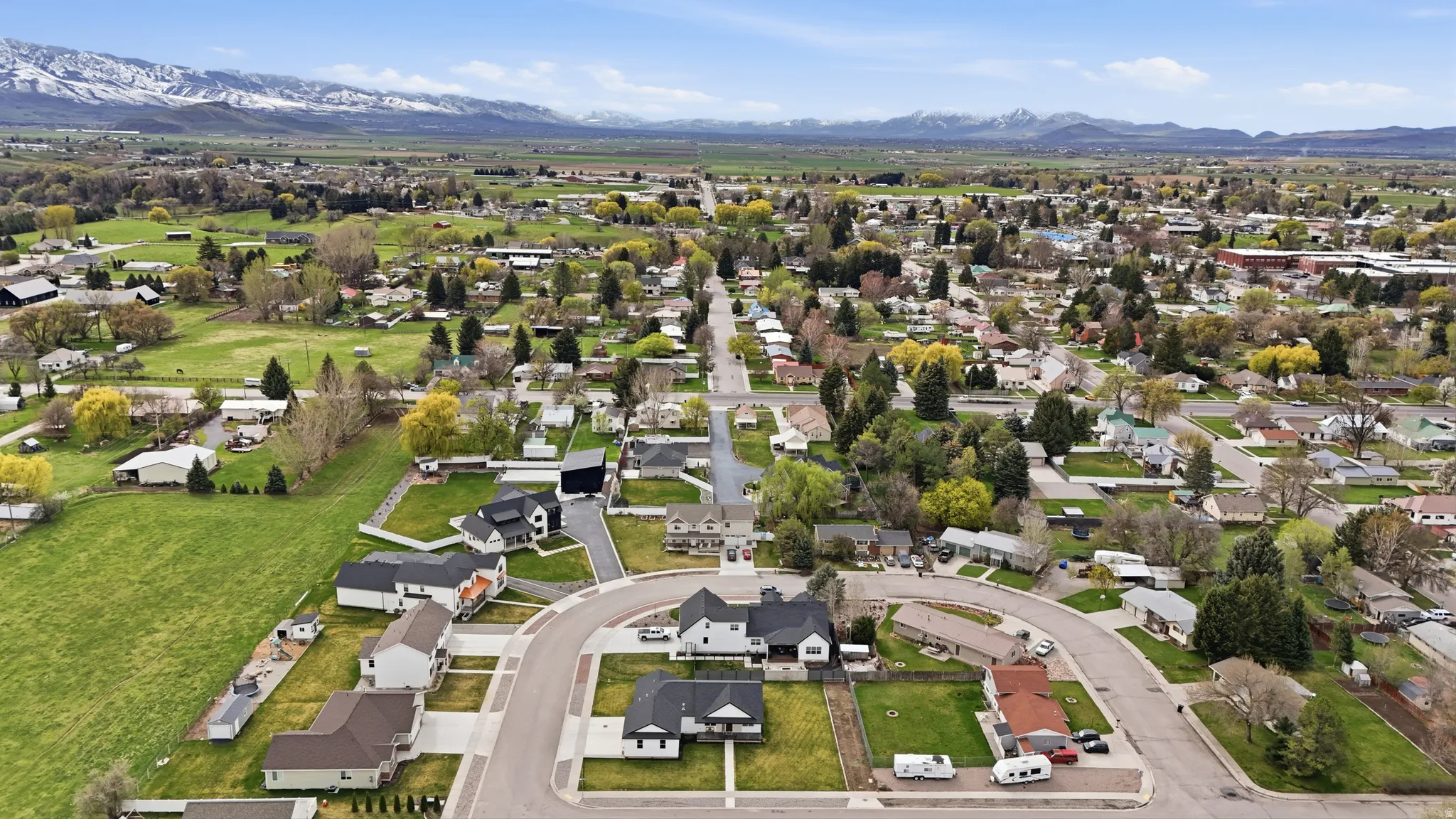 Aerial overview of property's location featuring nearby suburban area and a mountain backdrop