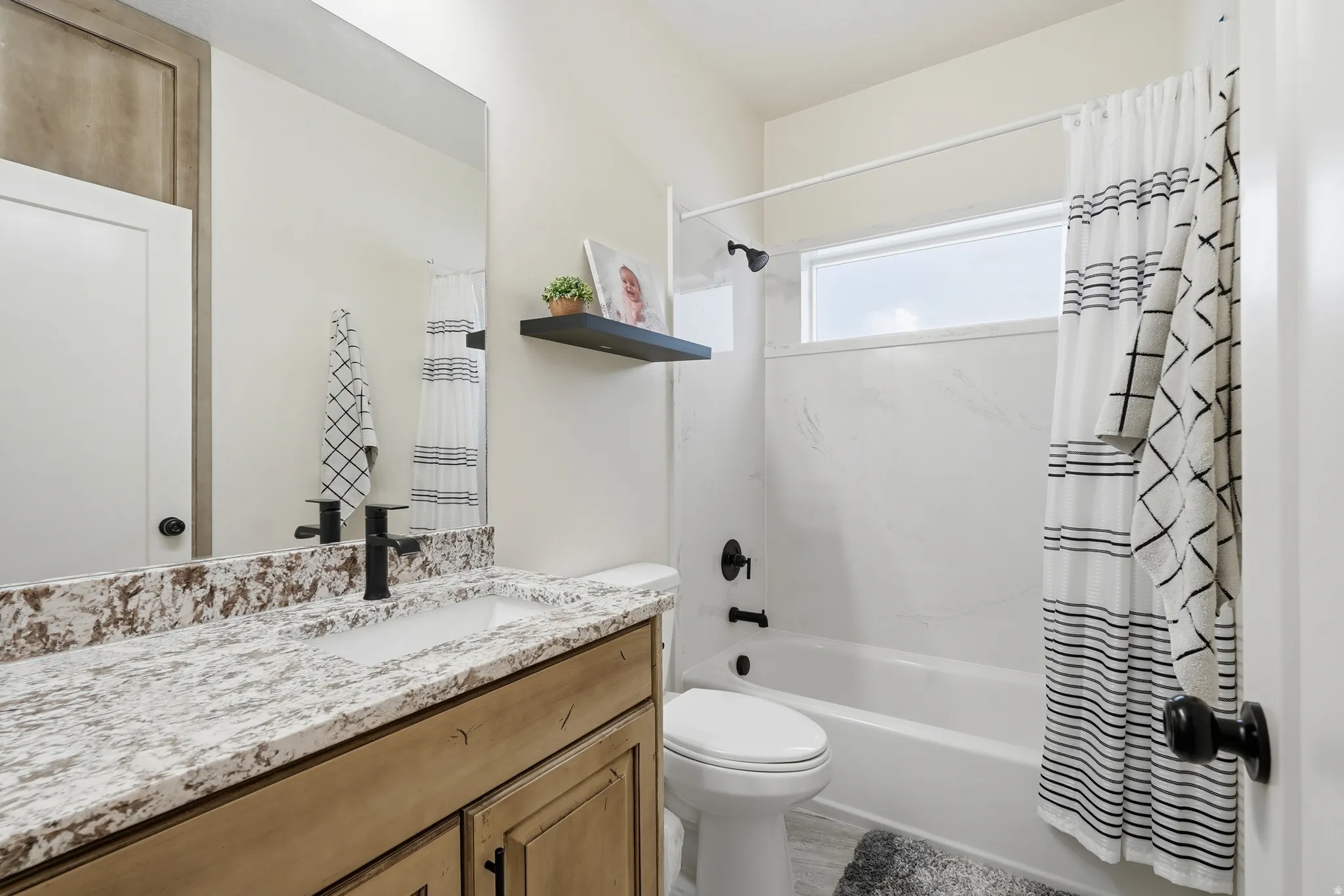 Full bathroom with vanity and shower / bathtub combination with curtain