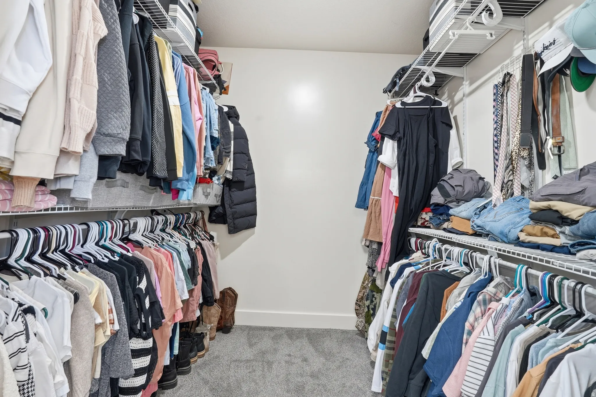 Walk in closet with light carpet