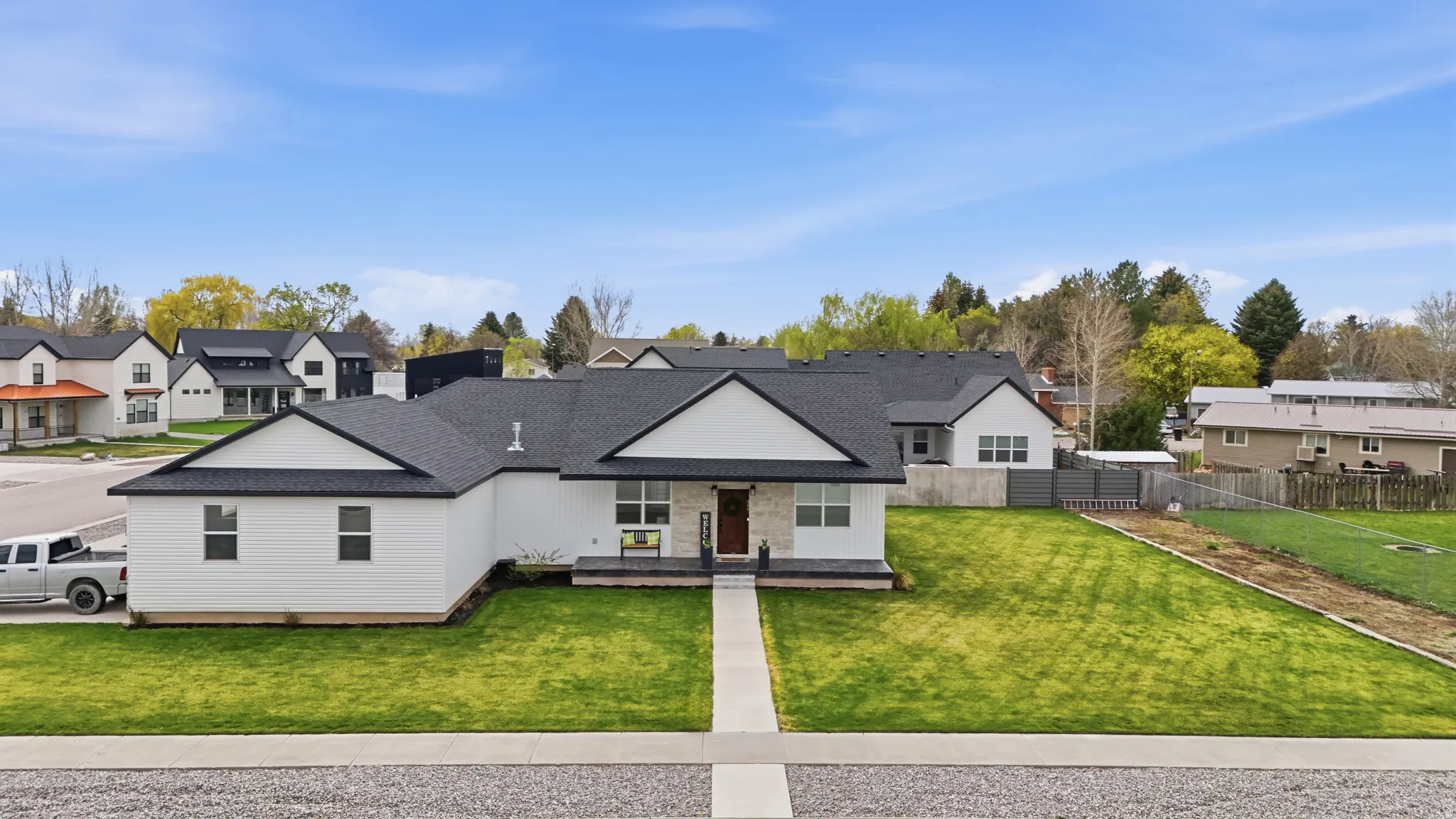 Modern farmhouse featuring a residential view and a shingled roof