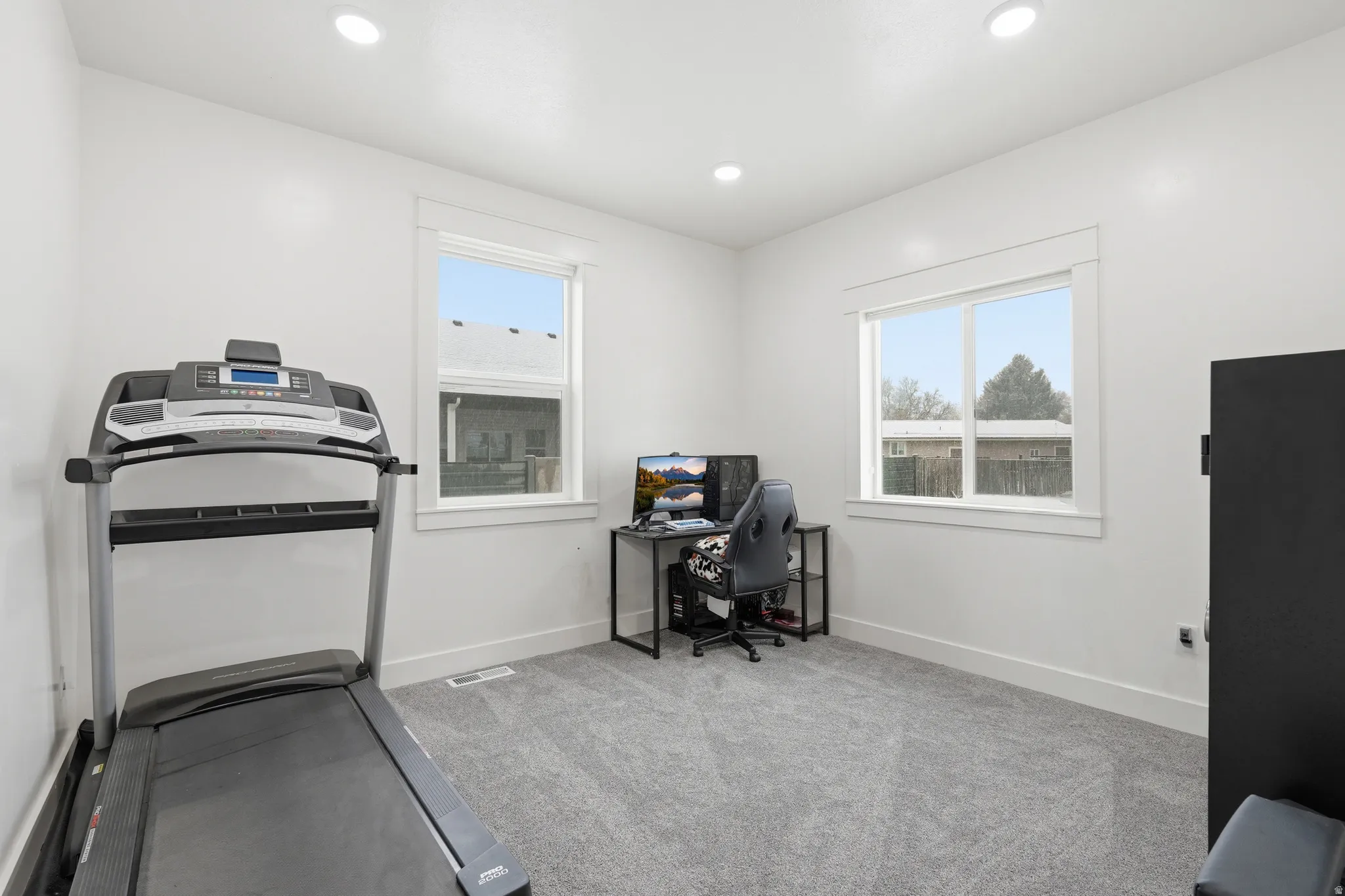 Exercise room featuring light colored carpet and recessed lighting