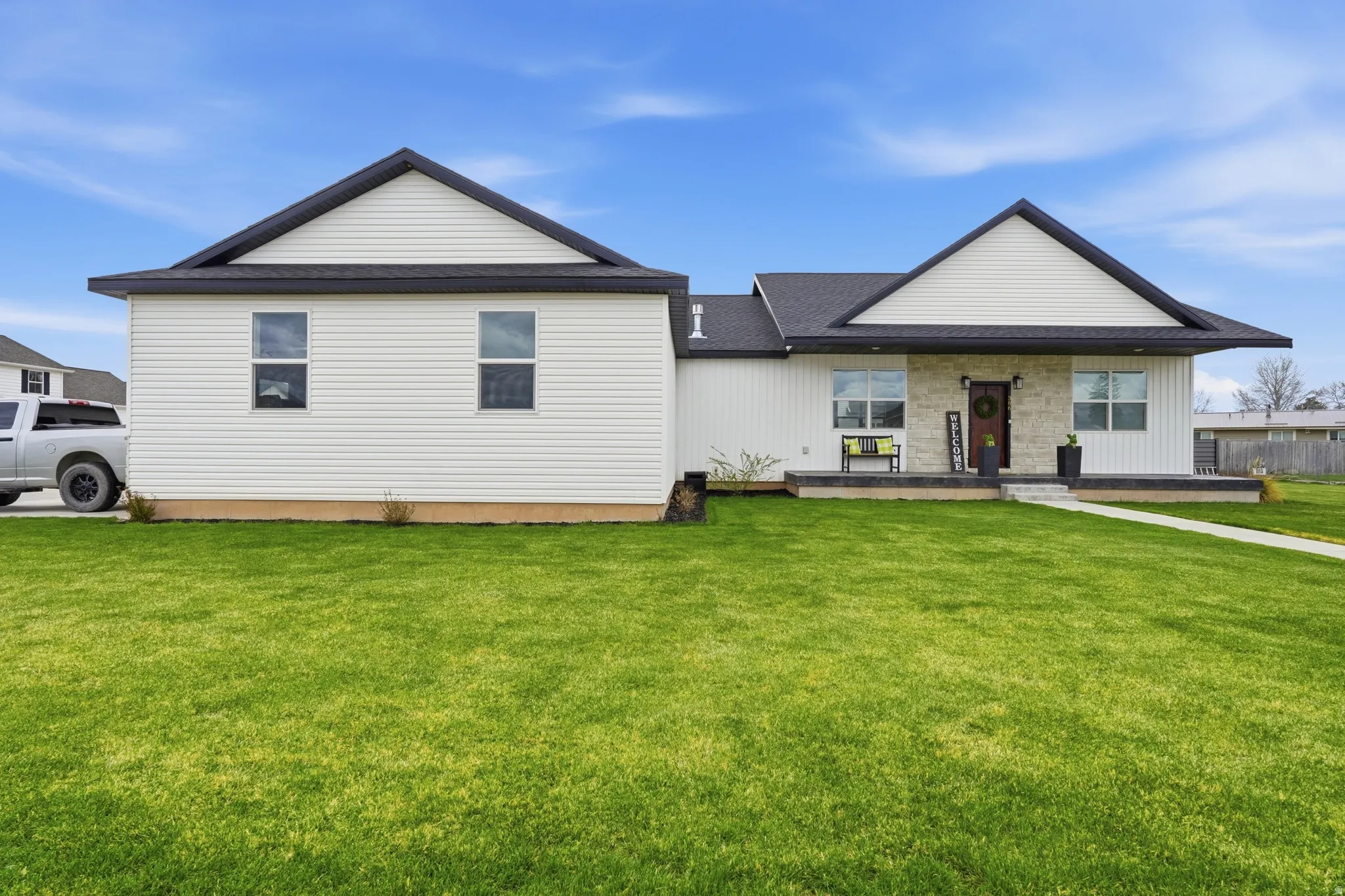 View of front of house featuring covered porch and a front yard