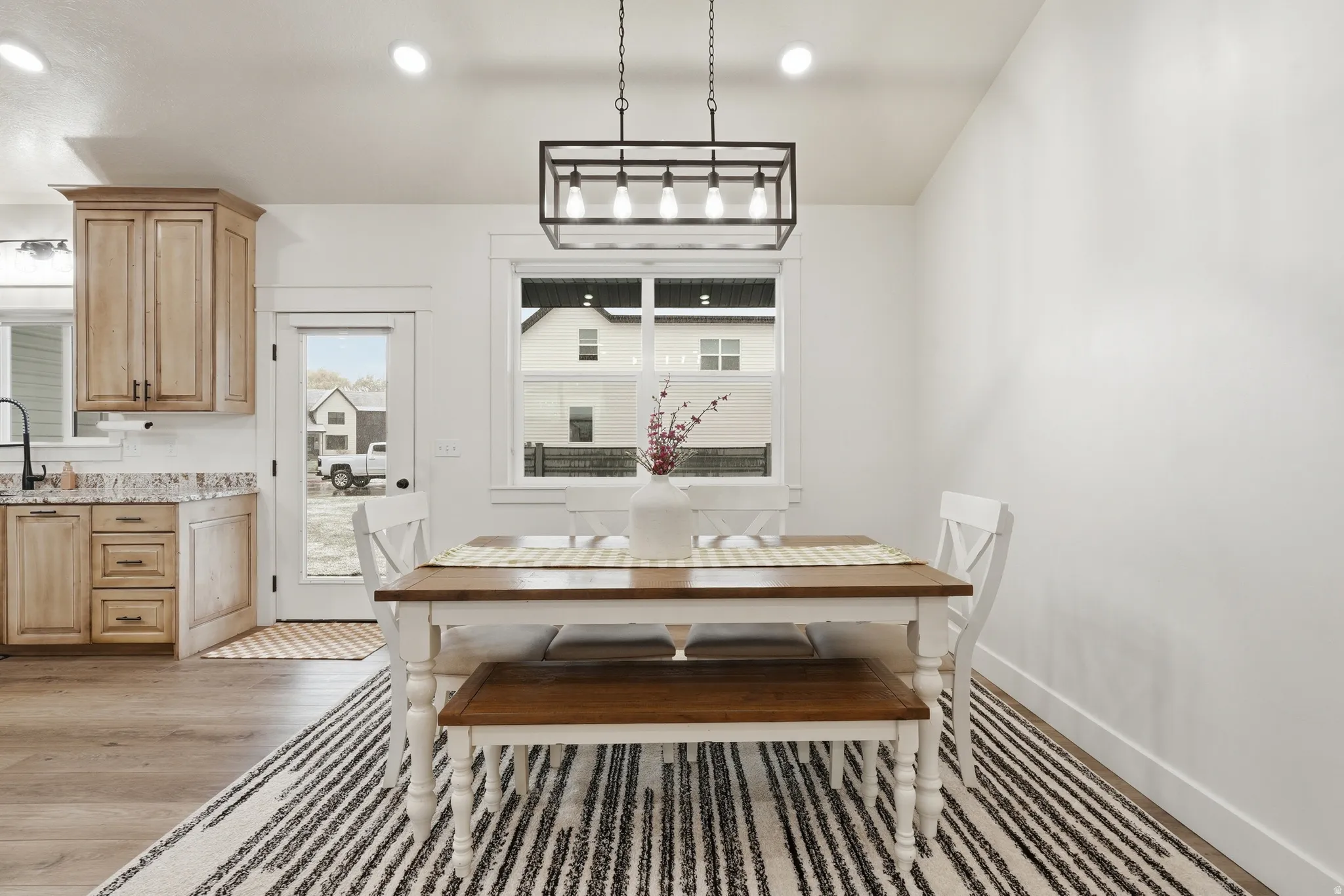 Dining space featuring light wood-type flooring and recessed lighting