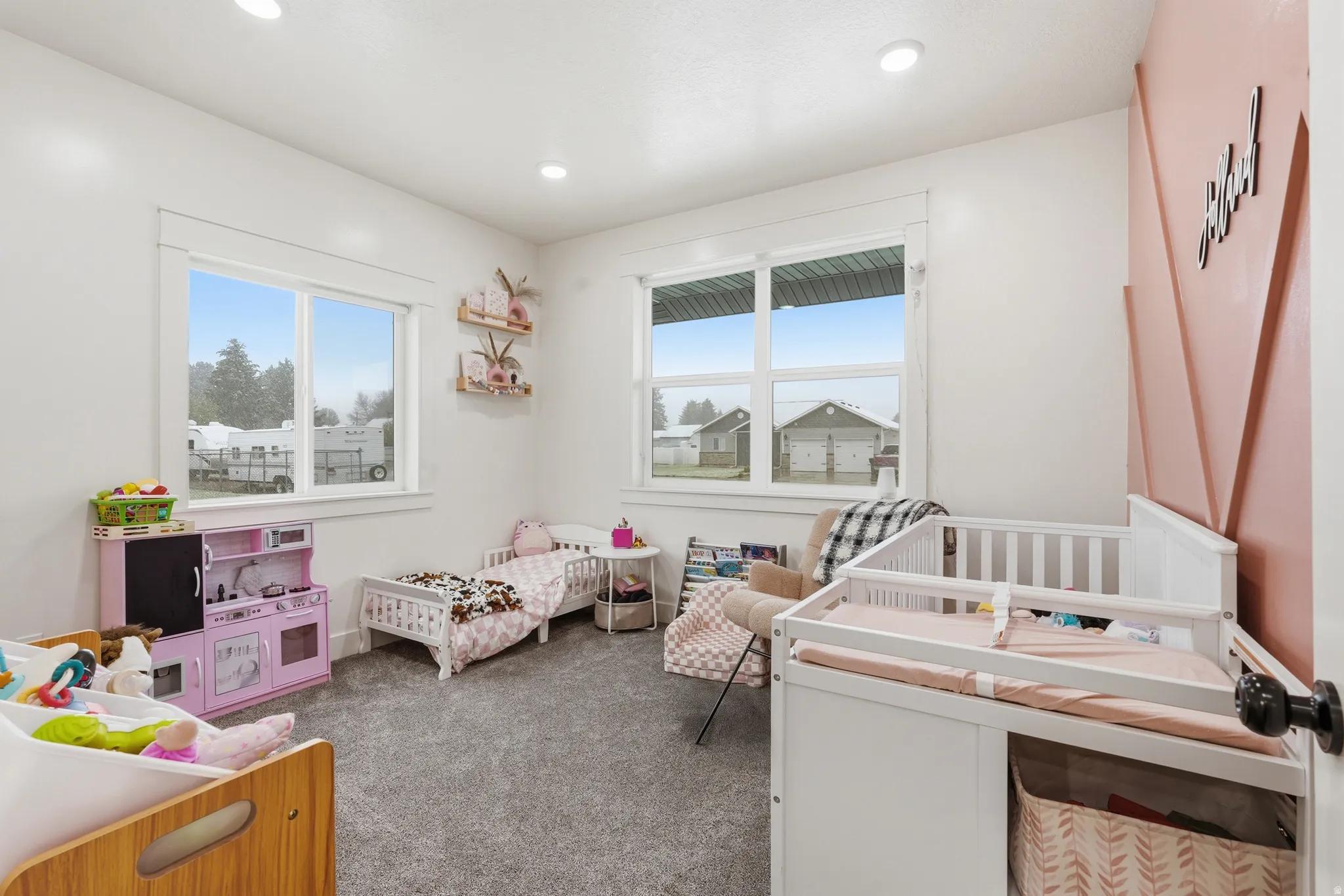 Bedroom with dark carpet, multiple windows, and recessed lighting