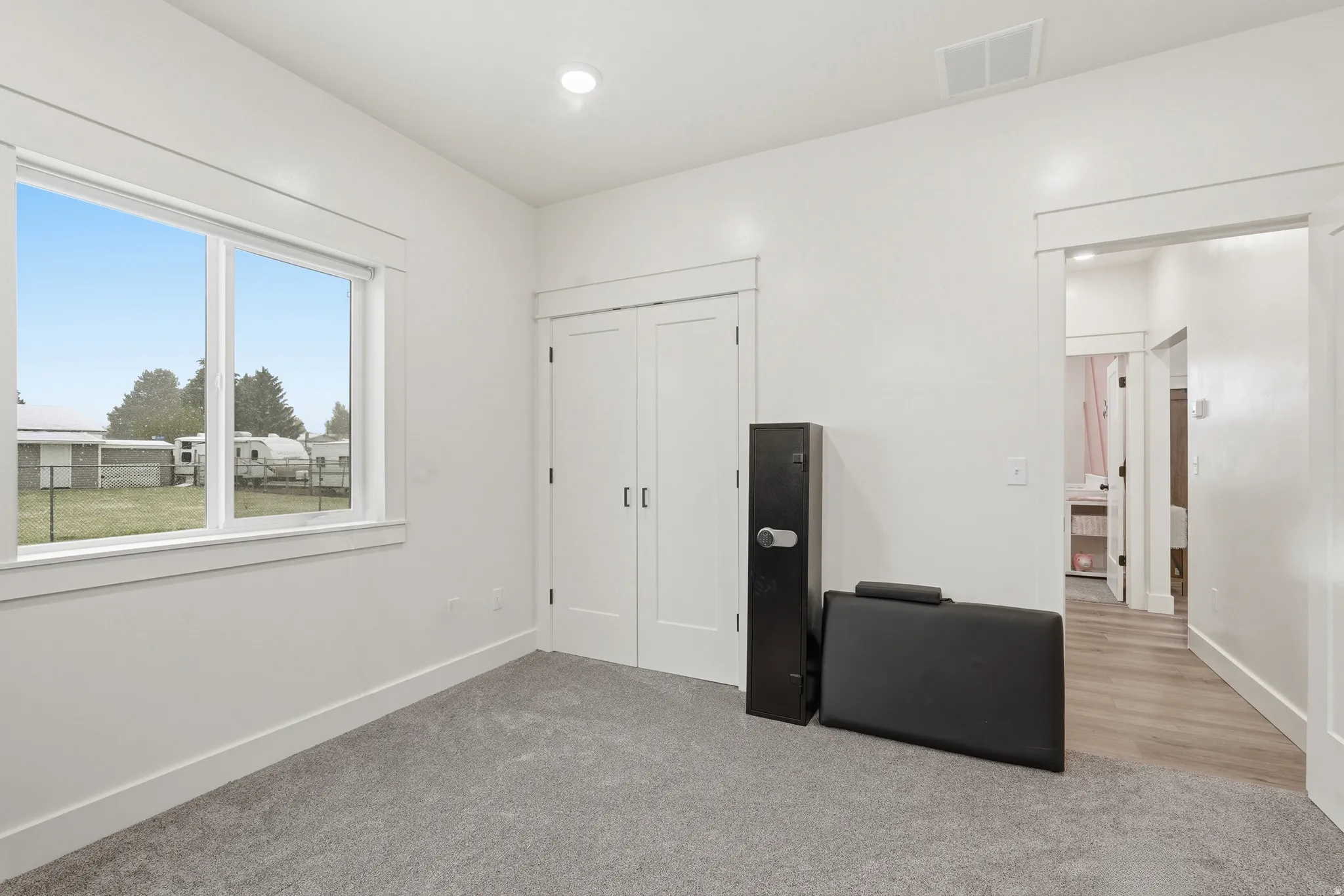 Unfurnished bedroom with light carpet, a closet, and recessed lighting