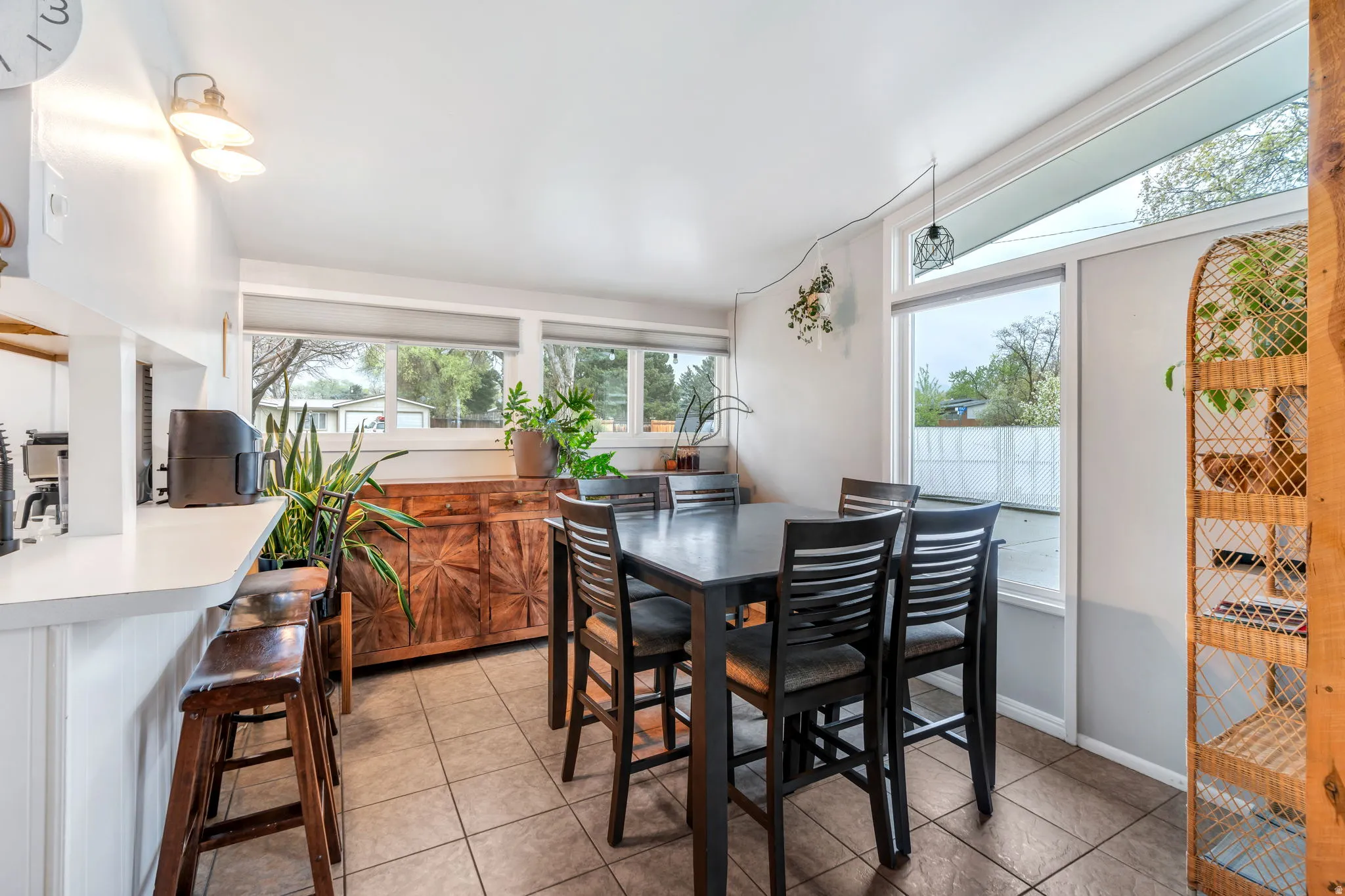 Dining space with light tile patterned flooring and baseboards