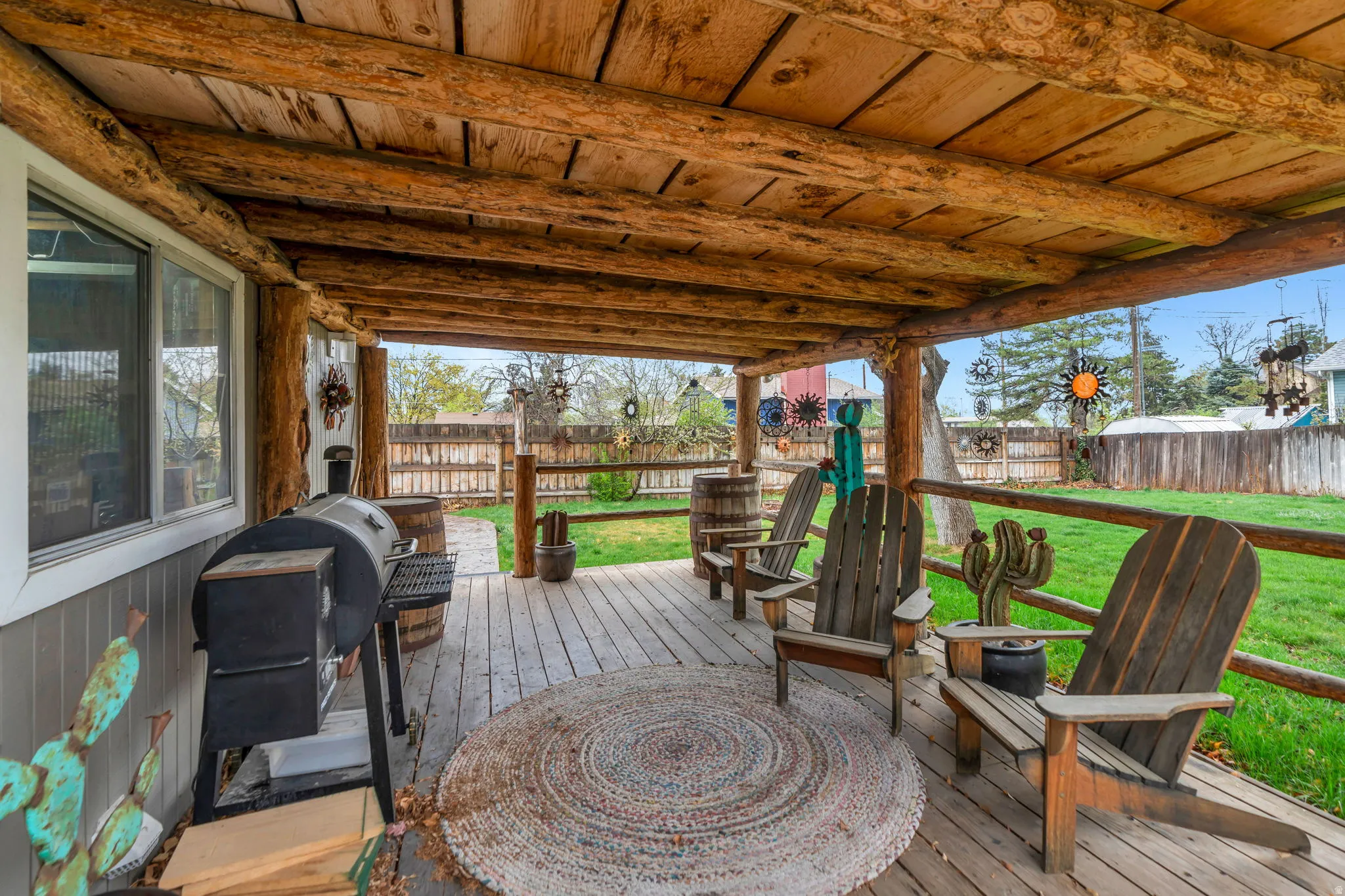 Wooden deck featuring a fenced backyard and grilling area