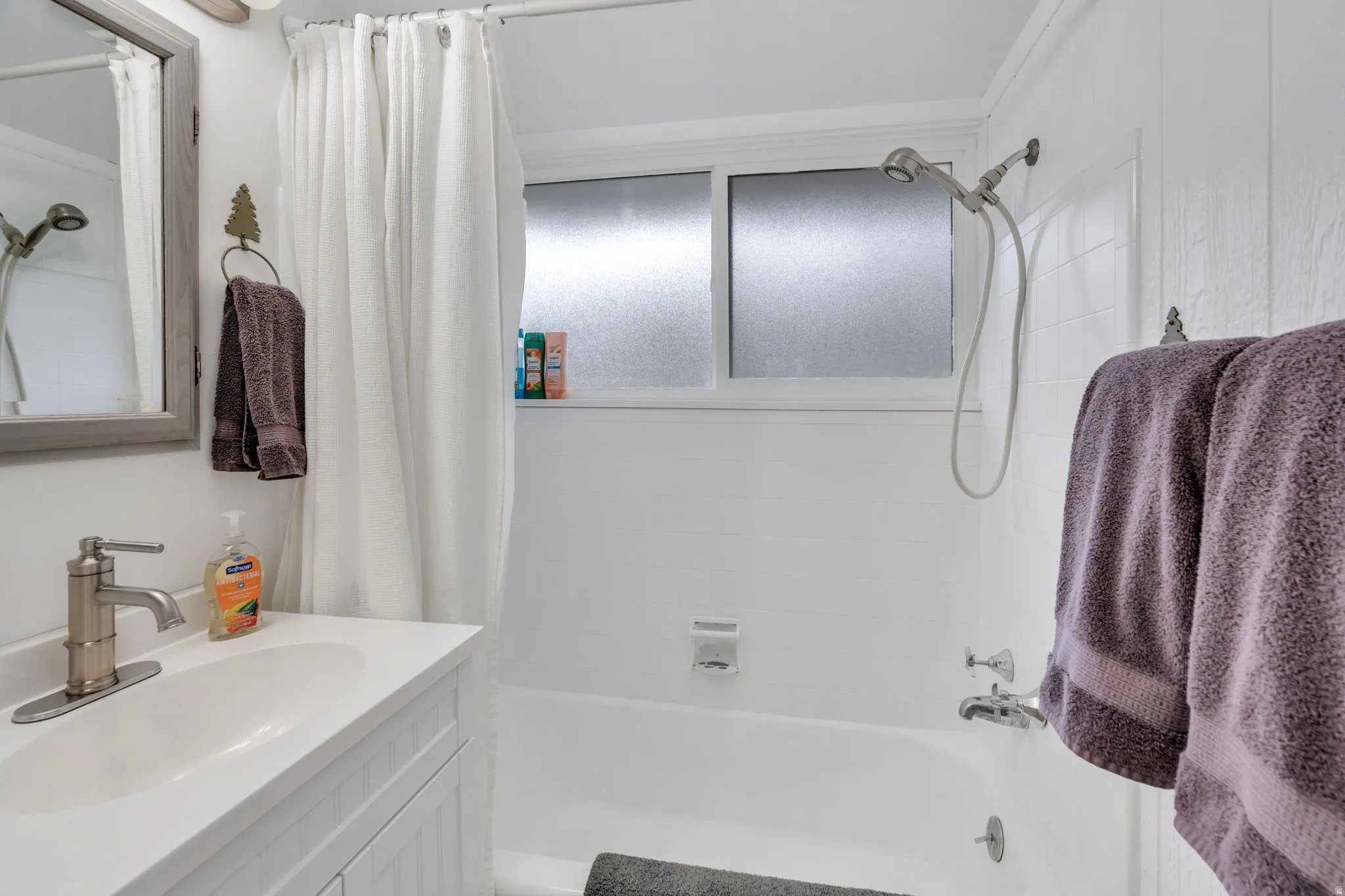 Bathroom with vanity and shower / tub combo with curtain