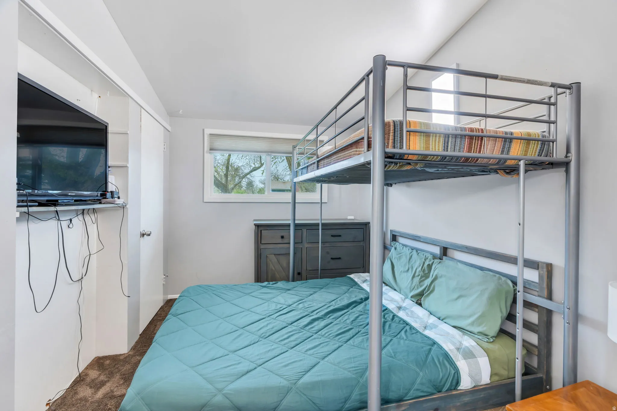 Bedroom featuring a closet and dark colored carpet
