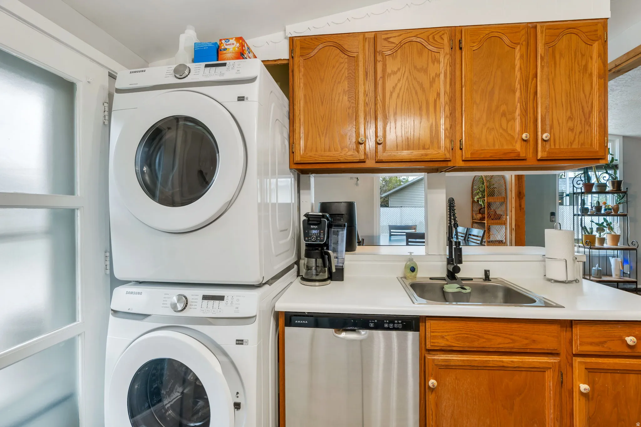 Laundry area featuring stacked washing machine and dryer