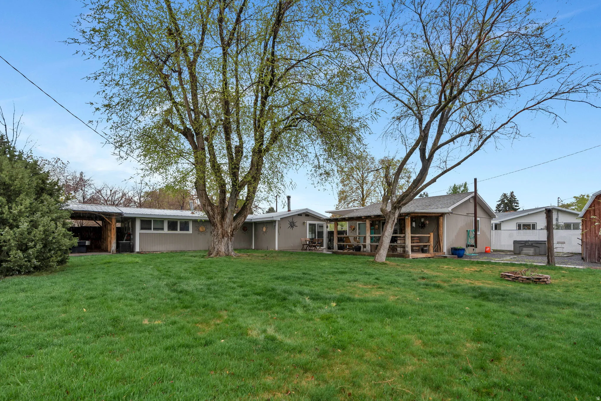 Rear view of property with a patio and a fire pit