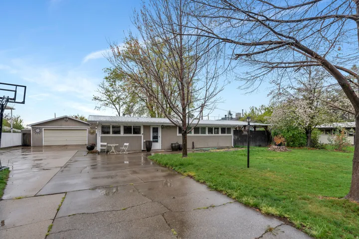 Ranch-style home with a detached garage and driveway