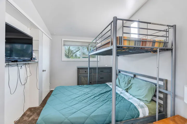 Bedroom featuring a closet and dark colored carpet