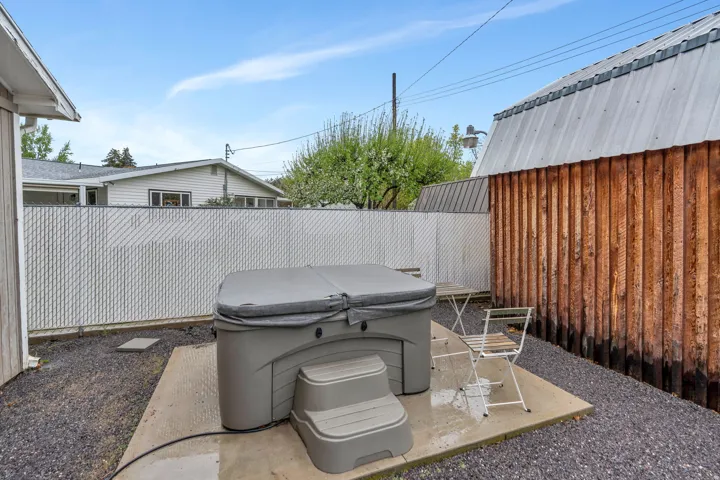 Fenced backyard with a patio area and a hot tub